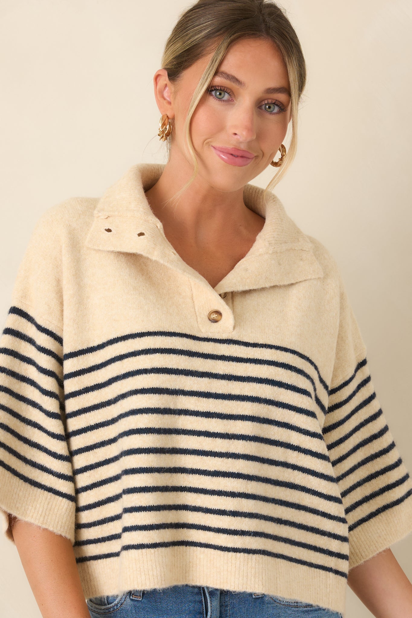 The front of this oversized top highlights the wide collar and navy striped pattern.