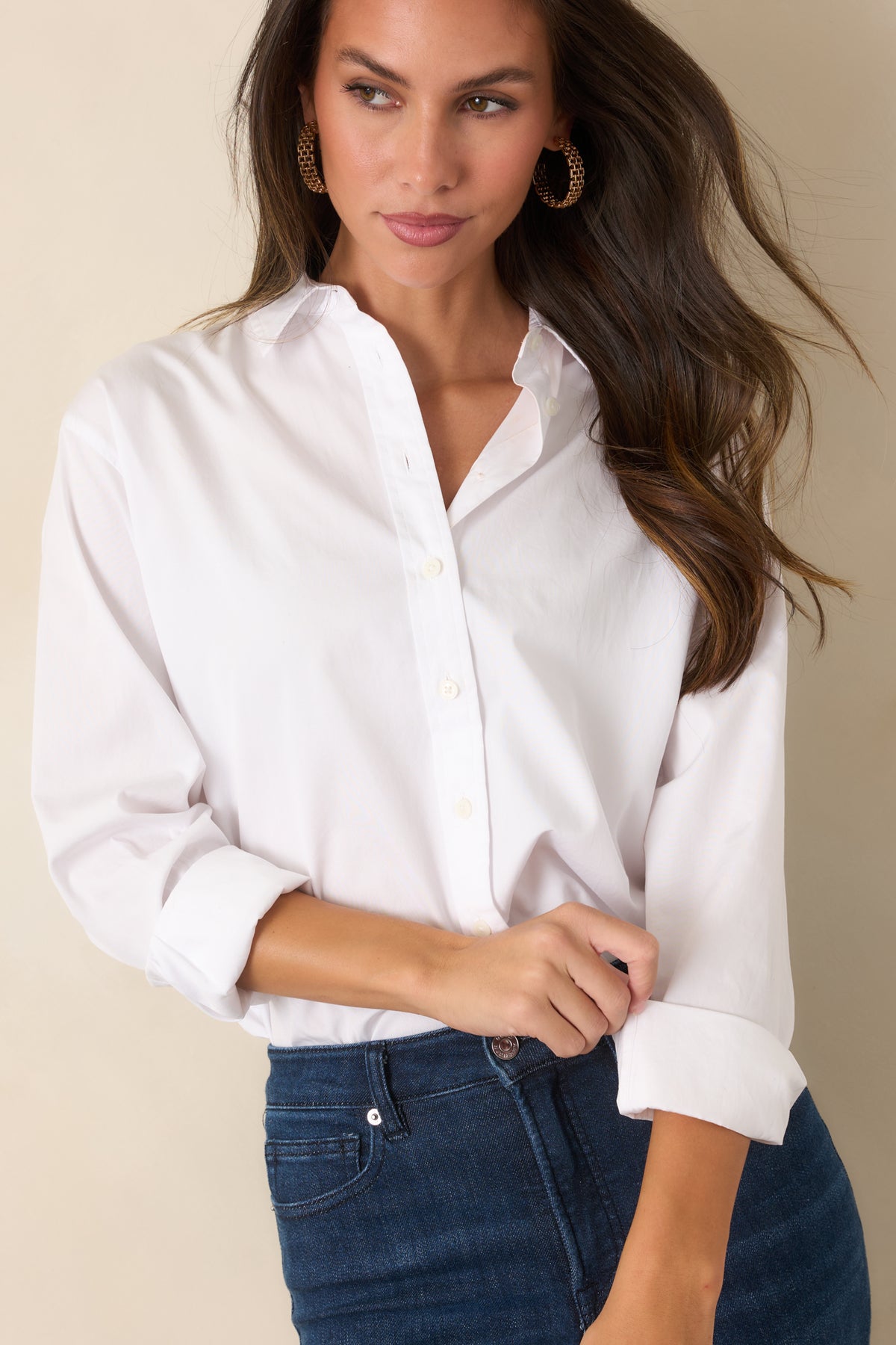 Oversized white shirt showcasing its roomy cut, long sleeves, and structured poplin finish.