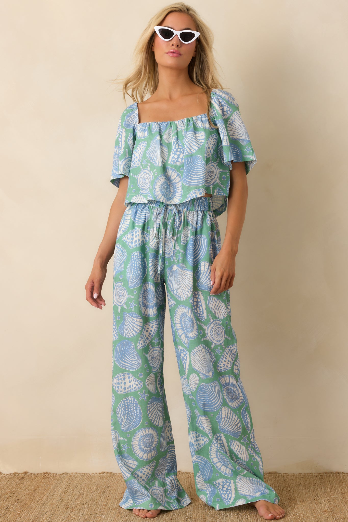 Blue multi wide-leg pants with elastic waistband and adjustable drawstring tie for a relaxed fit.