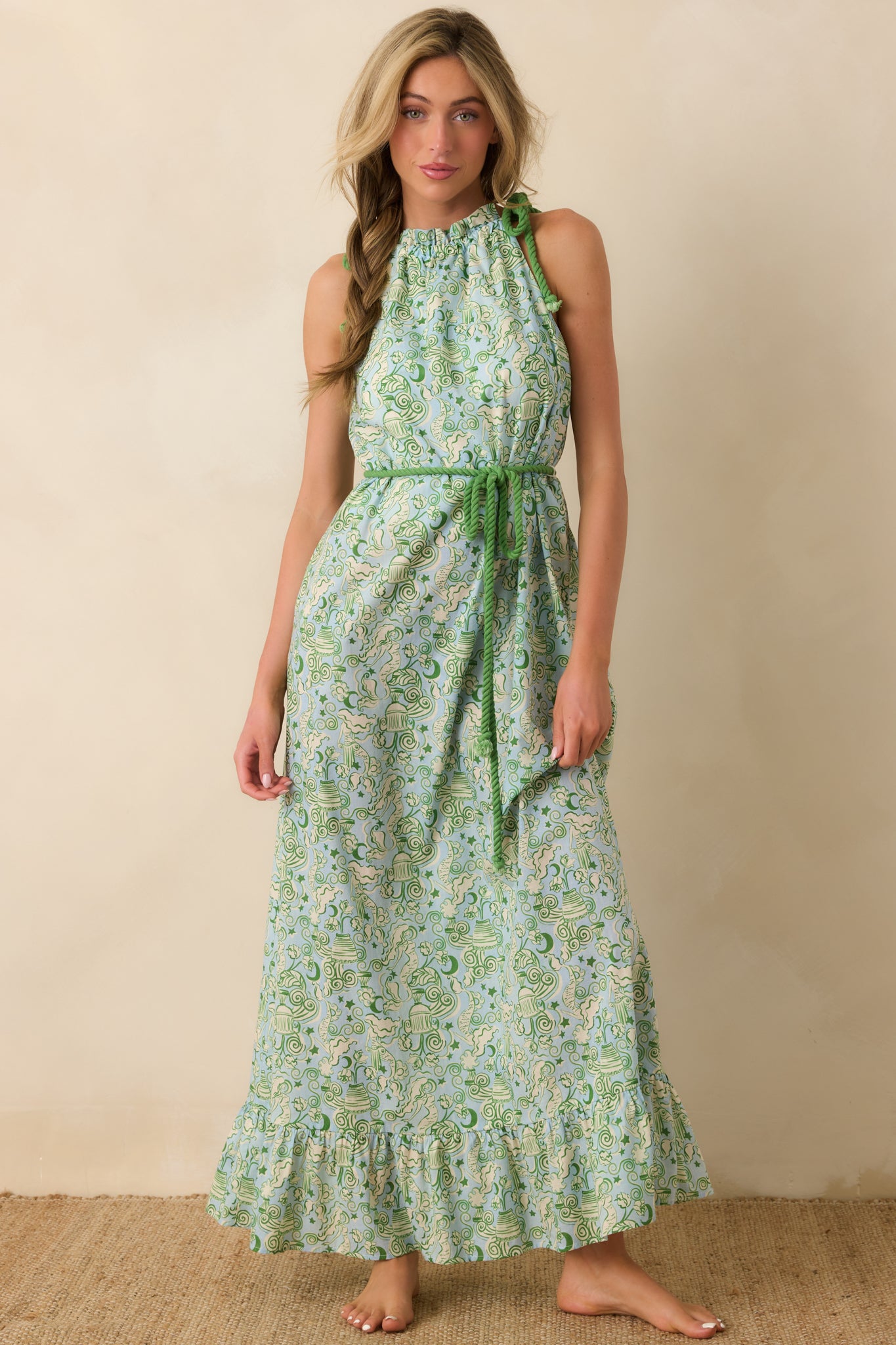 Green sleeveless cotton maxi dress with adjustable shoulder rope ties and a flowing ruffled hem.