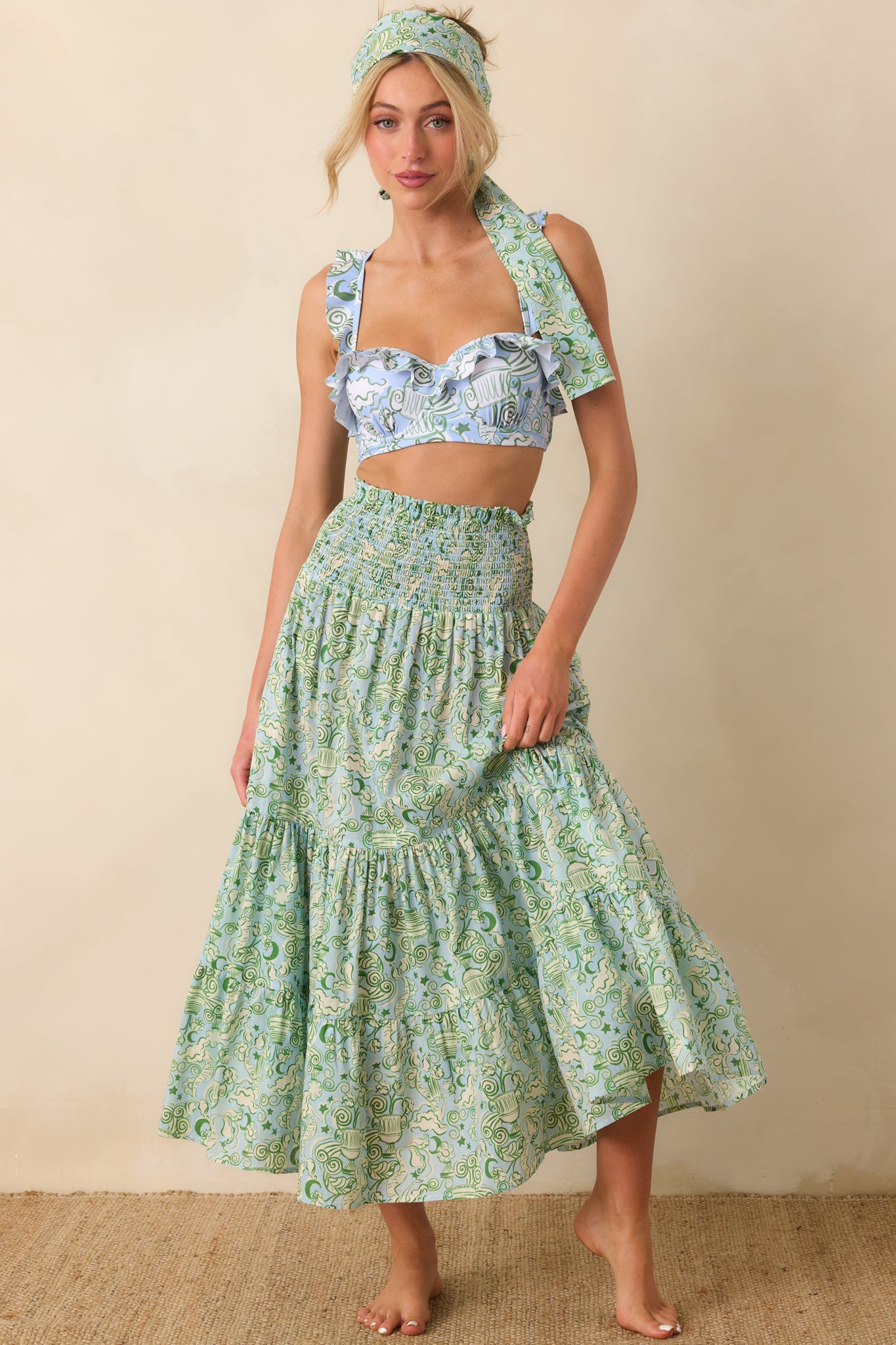 Convertible green maxi with elastic smocking at the bodice and relaxed, draped skirt.