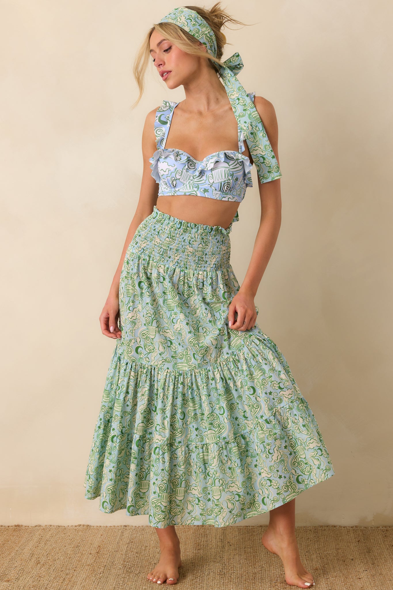Green convertible dress with elastic smocked bodice and relaxed maxi skirt silhouette.
