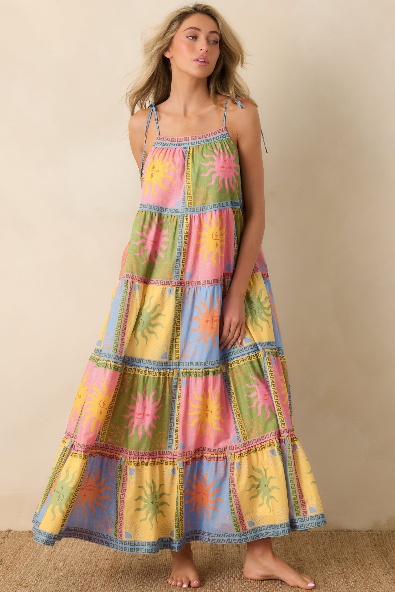 Front view of the breezy maxi dress showcasing adjustable tie shoulder straps and a relaxed, airy bodice that transitions into a voluminous skirt.