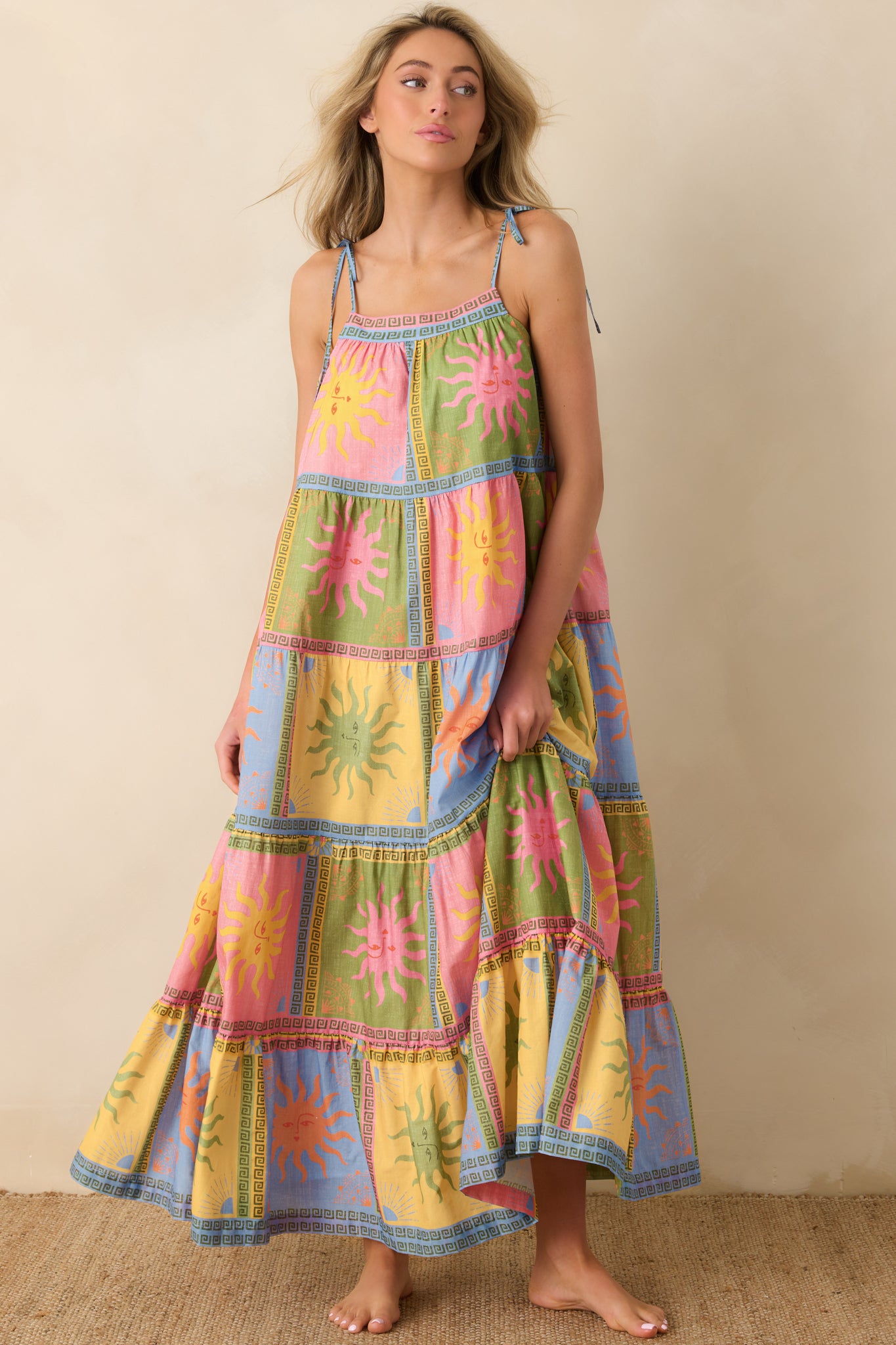 Vibrant multi-color maxi highlighting layered tiers and bold patterned panels that create soft movement through the full-length design.