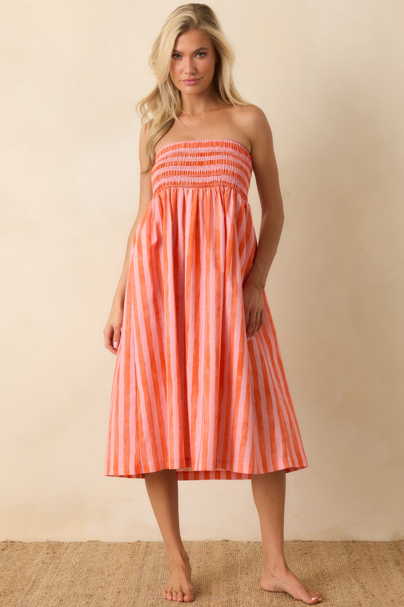 Striped midi dress showcasing a relaxed silhouette with a flowing skirt and airy summer-ready construction.