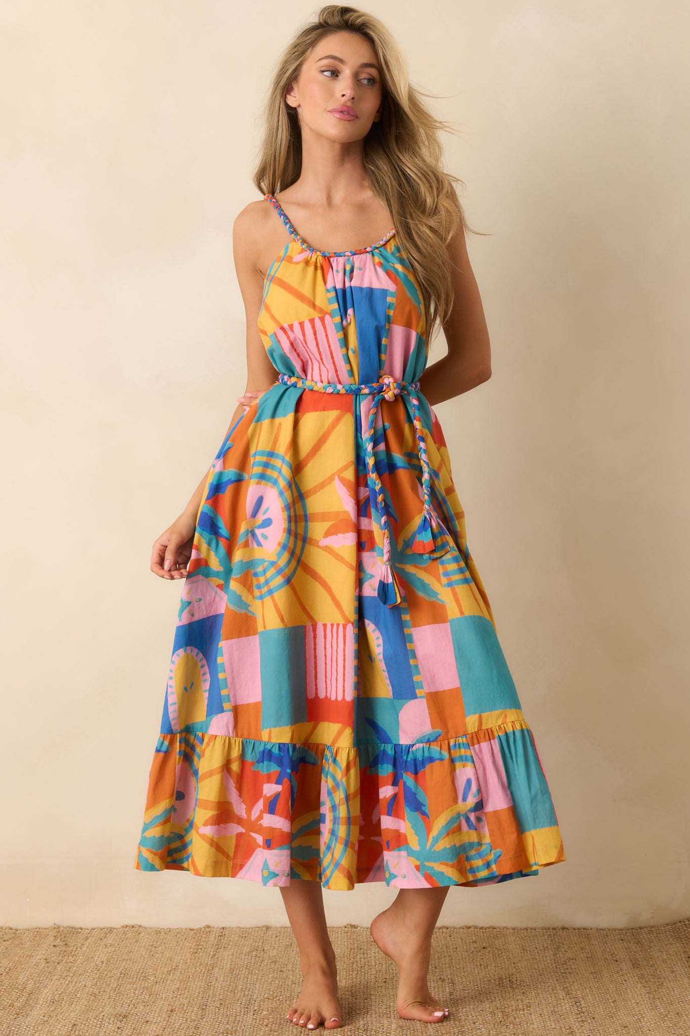 Tropical mosaic print midi dress featuring side pockets, adjustable straps, and a breezy midi-length tiered skirt.