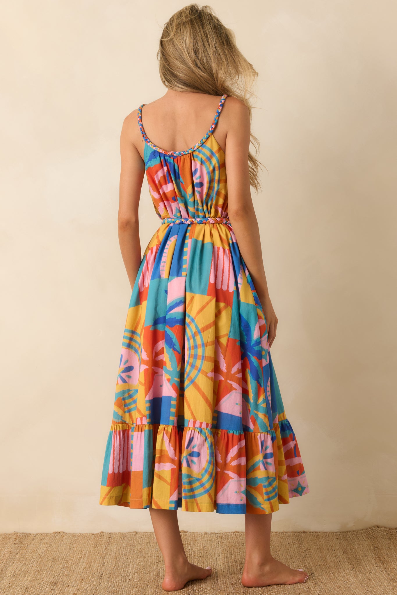 Rear view of the multi tropical mosaic print midi dress featuring adjustable spaghetti straps and a tiered midi skirt with flowing movement.