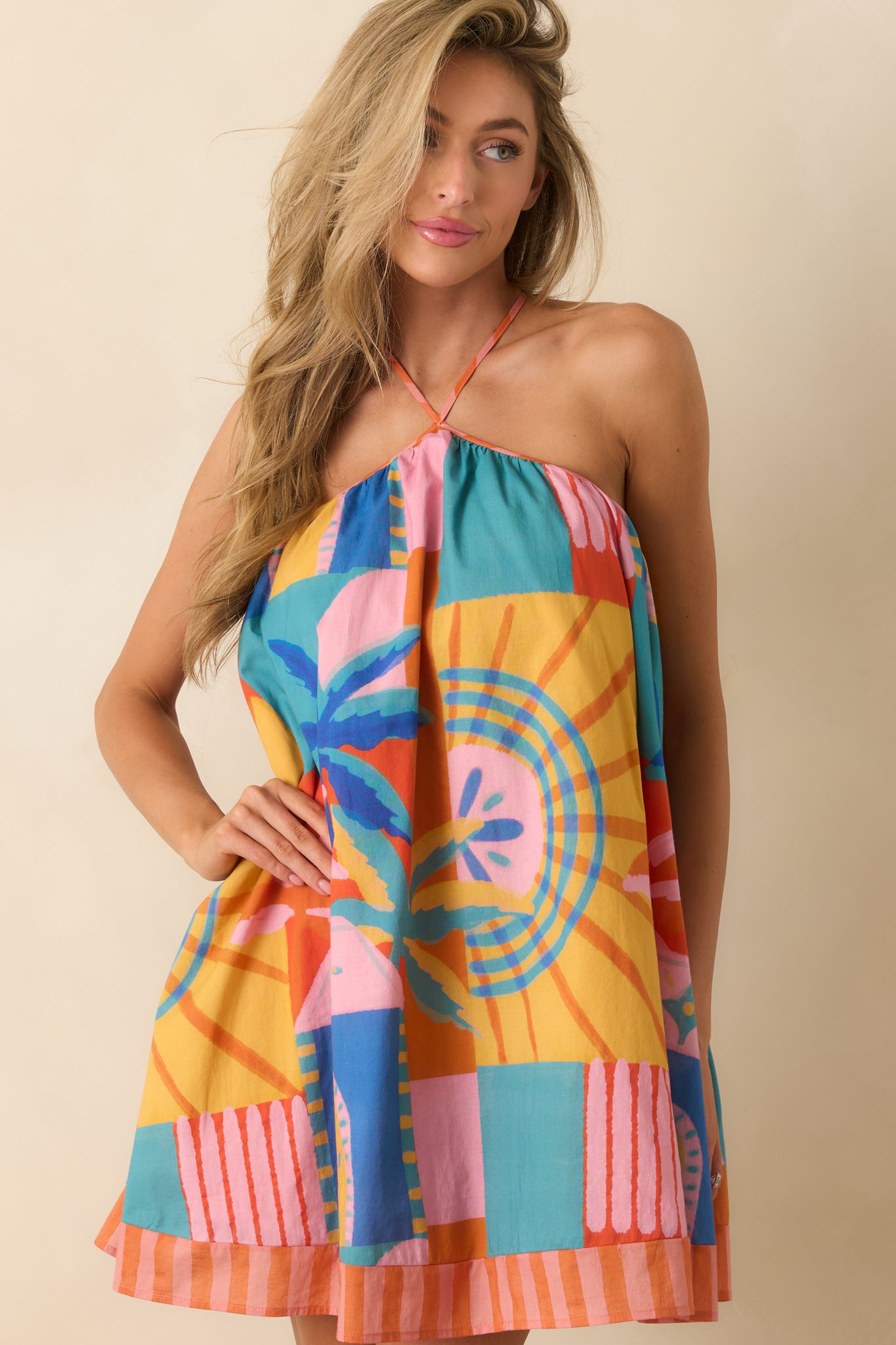 Detailed look at the lightweight cotton fabric and vibrant mosaic print pattern on the swing silhouette dress.