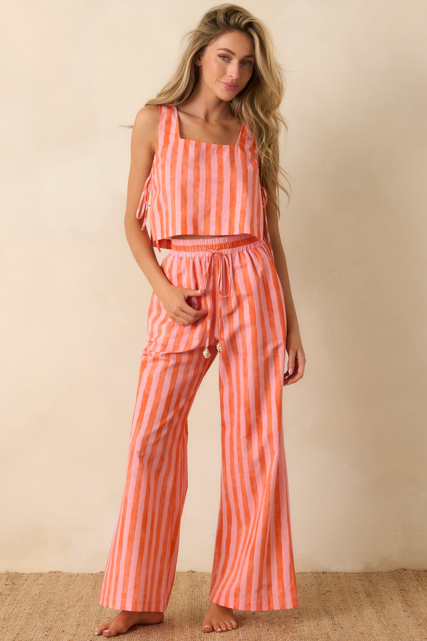 Lightweight linen blend pants with a breezy wide leg fit, colorful stripe pattern, and shell-inspired bead accents on the drawstring.