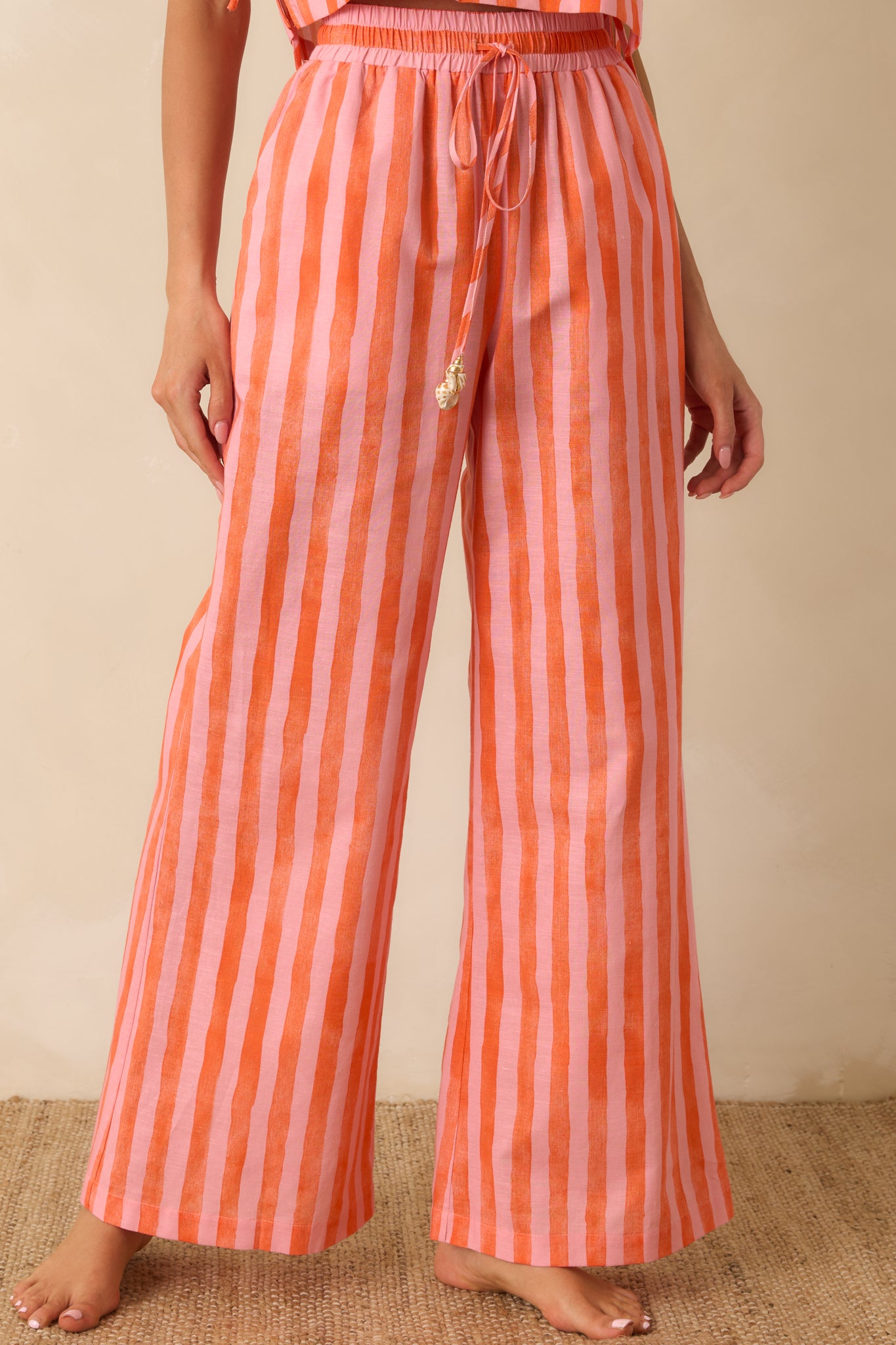 Cropped front view of the striped pants showcasing the vibrant color palette and functional side pockets.