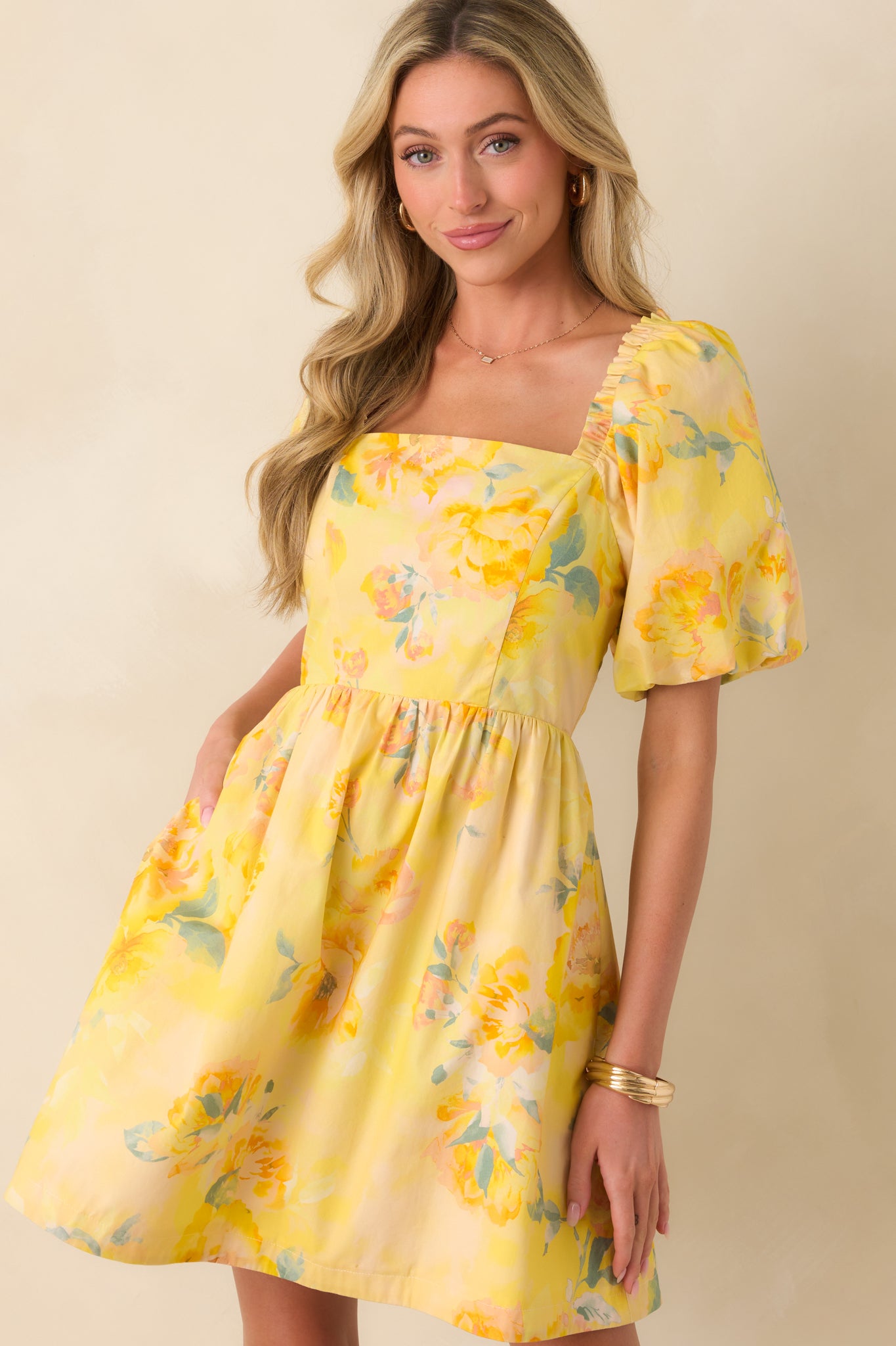 Close view of square neckline with fitted bodice and soft puff sleeve detailing.