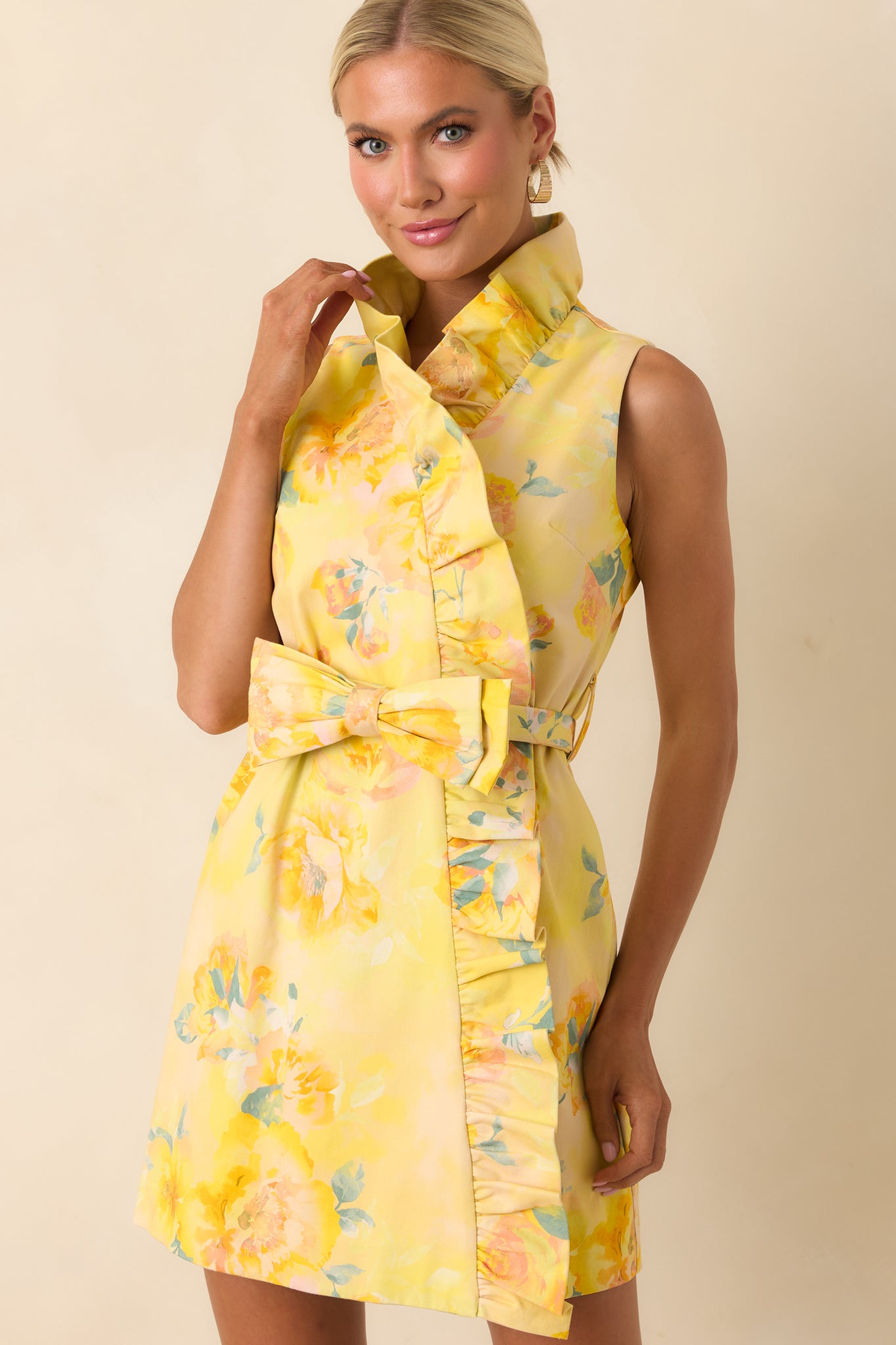 Close view of sleeveless bodice with soft ruffled collar and silky lightweight fabric texture.
