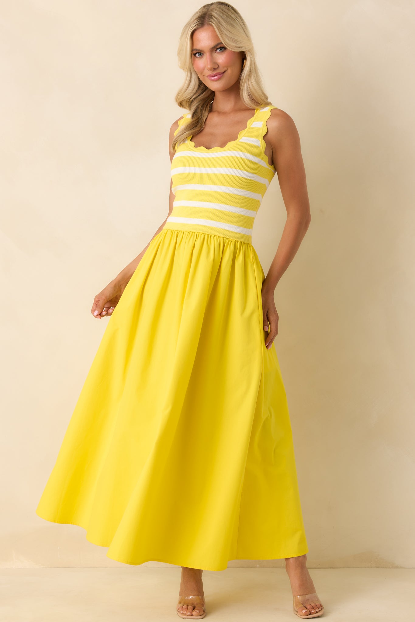 Sunny yellow midi dress showcasing a stripe knit bodice, optional waist belt, and fluid skirt with pockets.