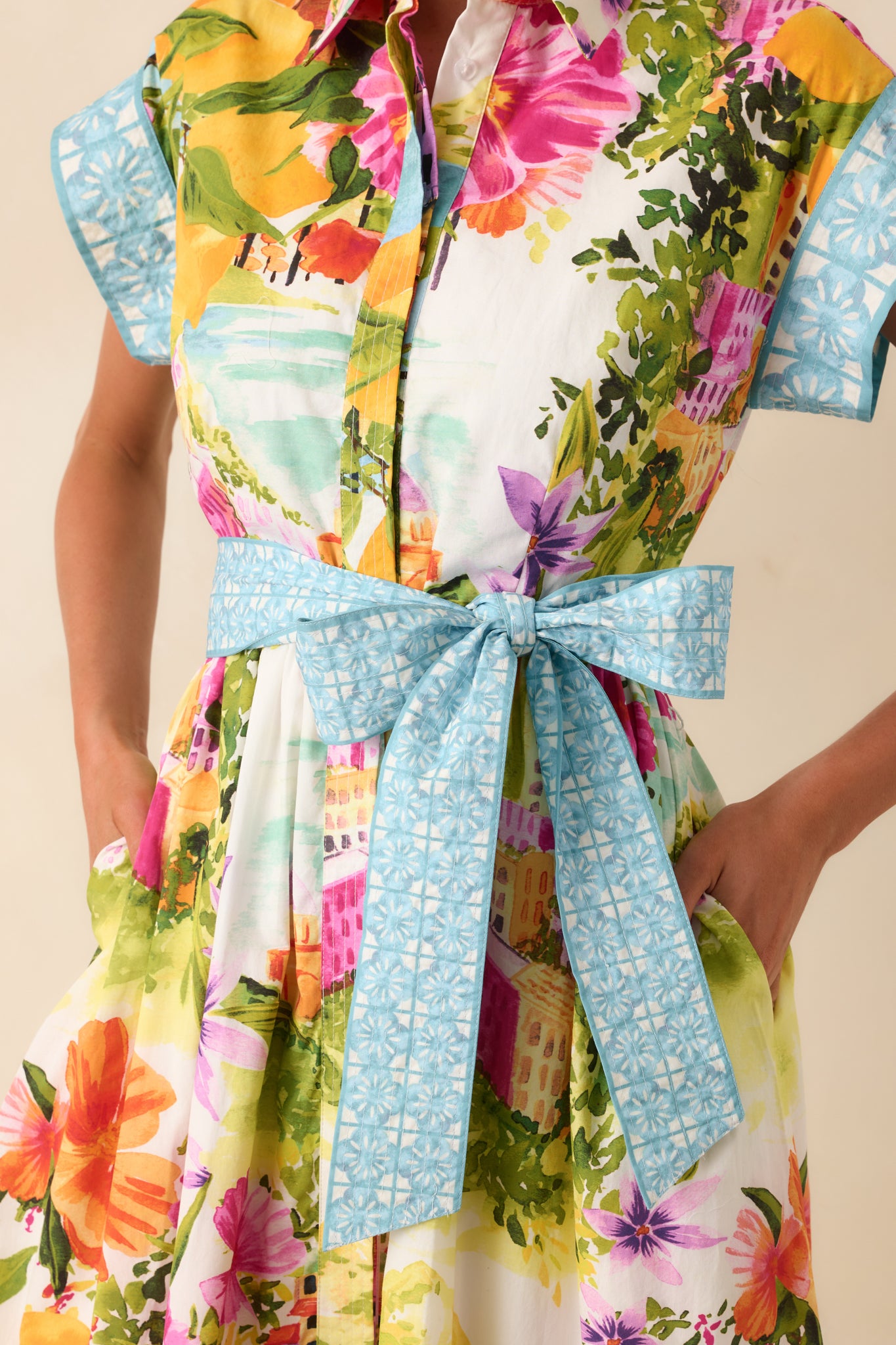 Button-front midi dress with cap sleeves, waist tie, and contrast blue detailing.
