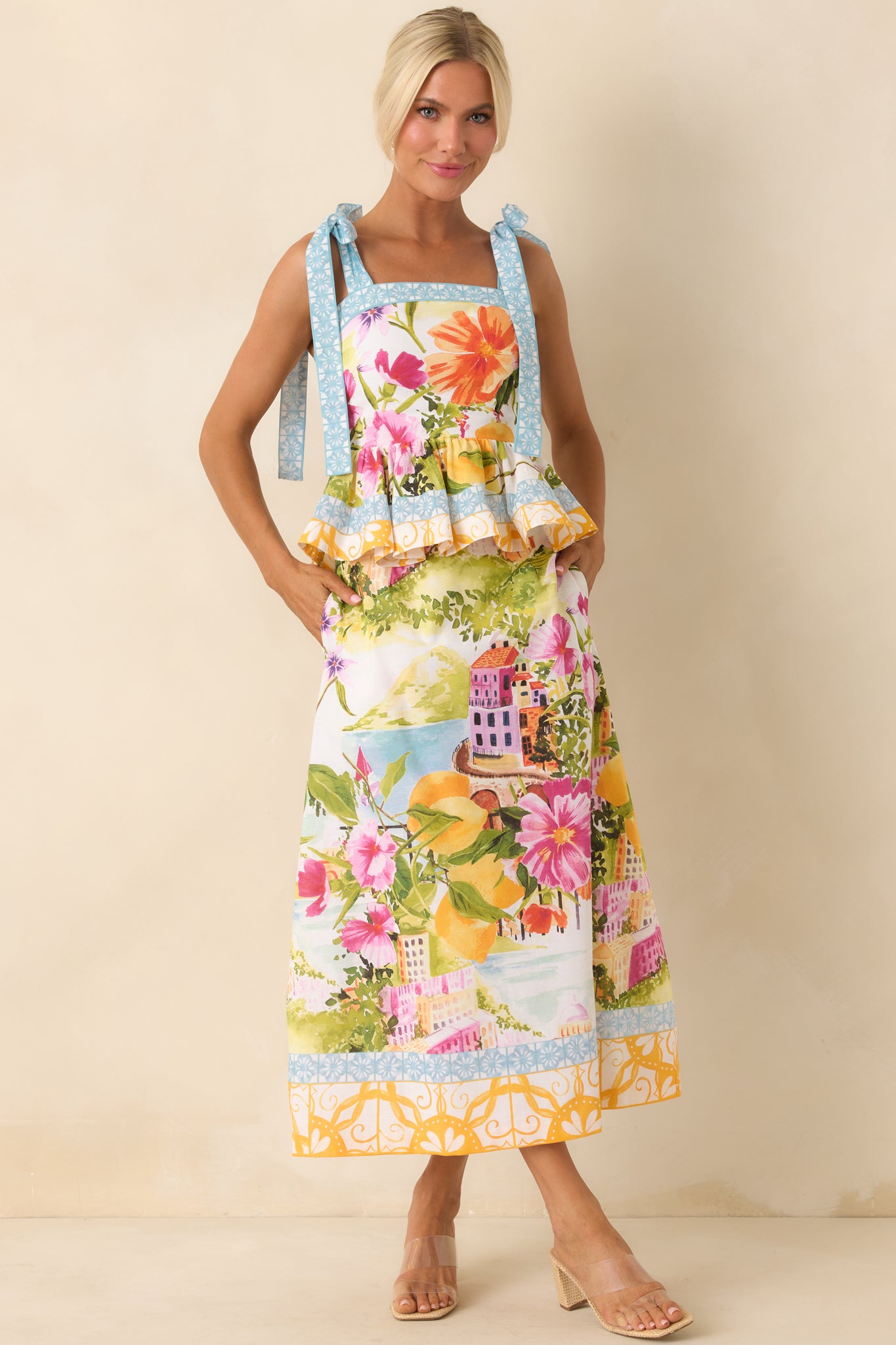 Front view of multi floral linen blend peplum top showing square neckline and adjustable tie straps.