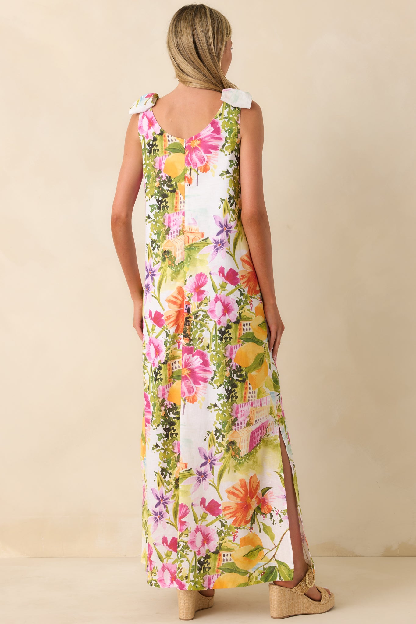 Rear view of maxi dress with relaxed silhouette and shoulder tie strap detail.