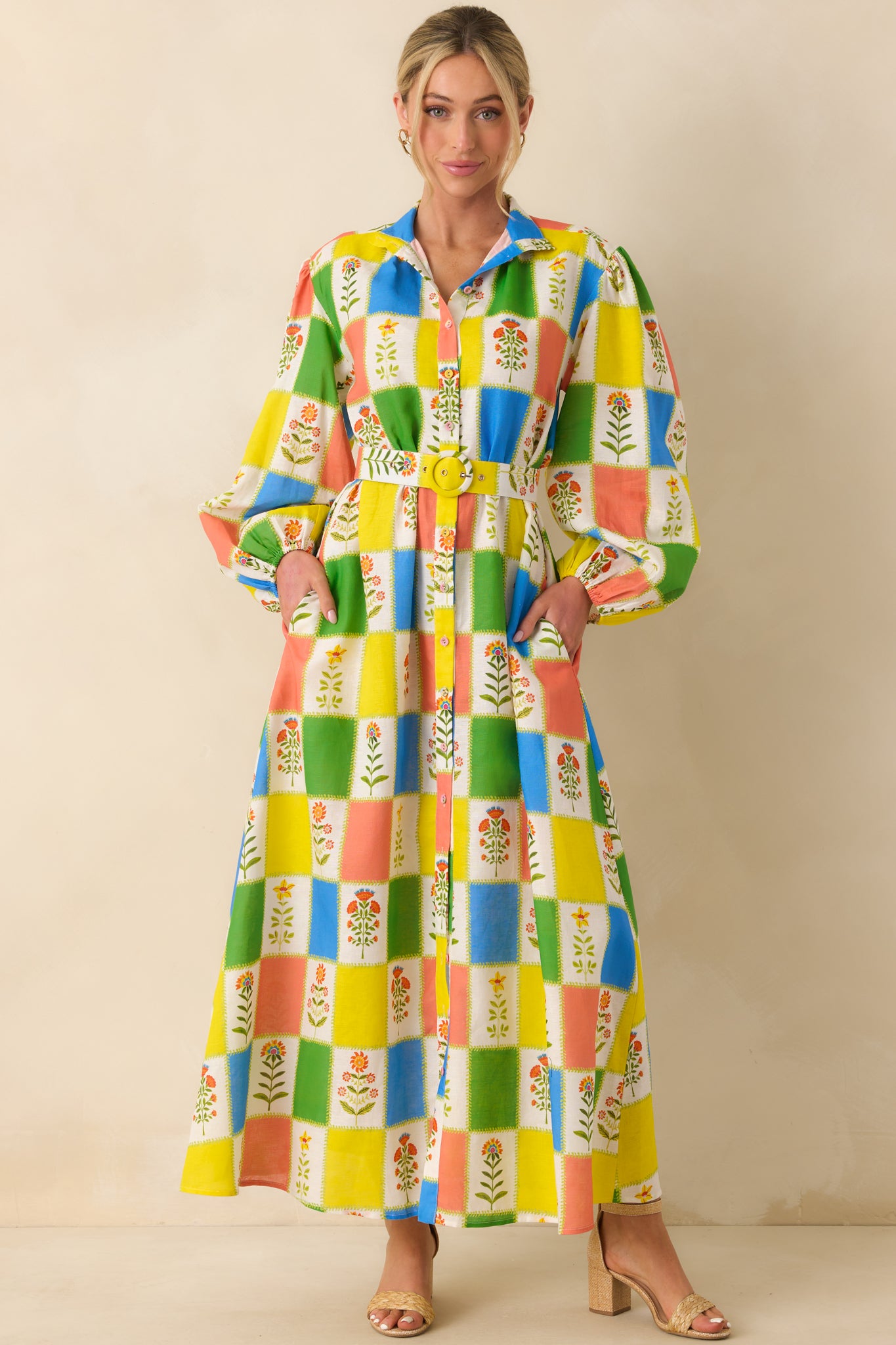 Button-front maxi dress highlighting a defined waist cinched with a matching belt and statement buckle, creating a flattering and polished shape.