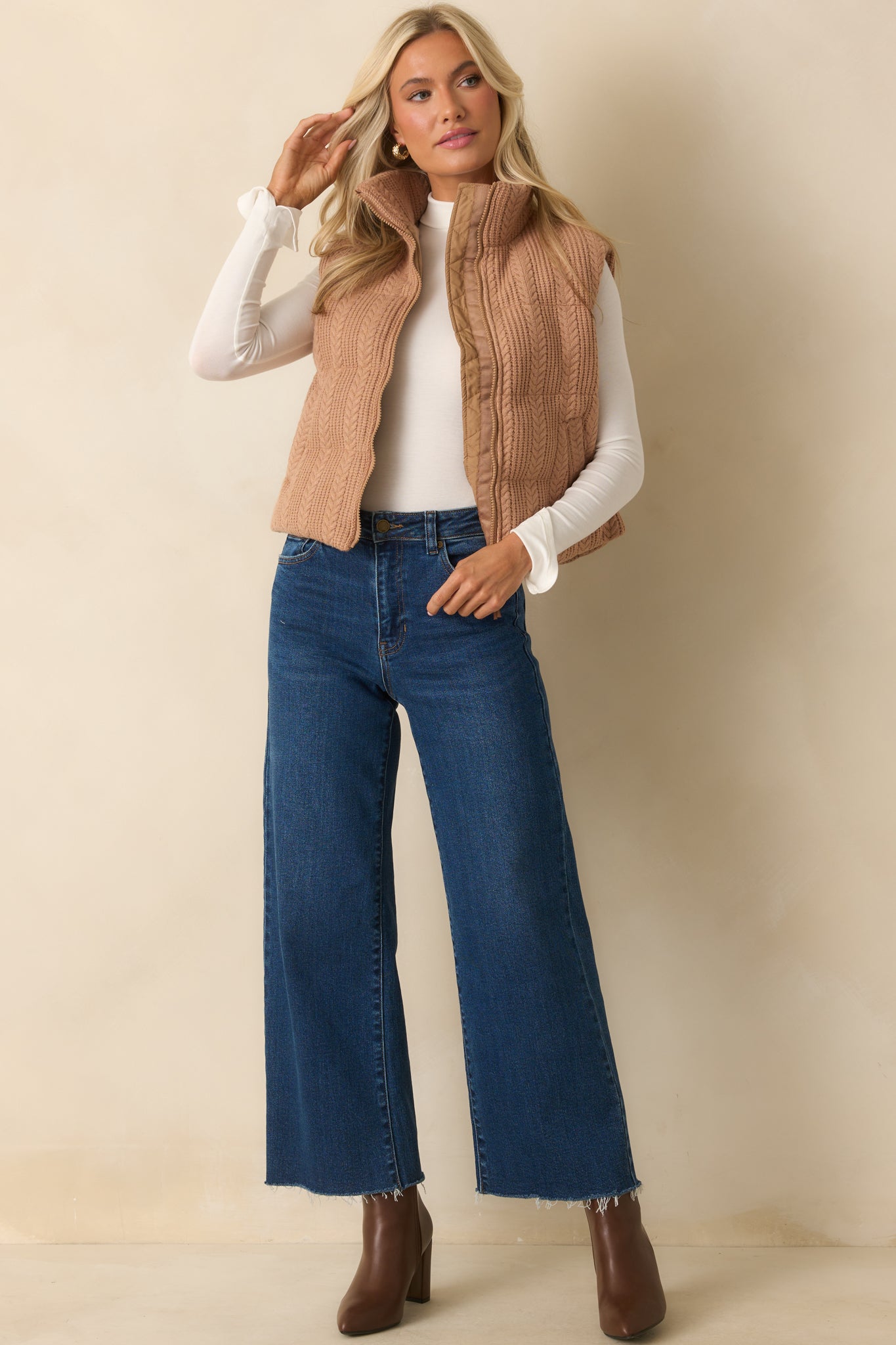 Lightly padded vest styled with functional zip front and smooth lining.