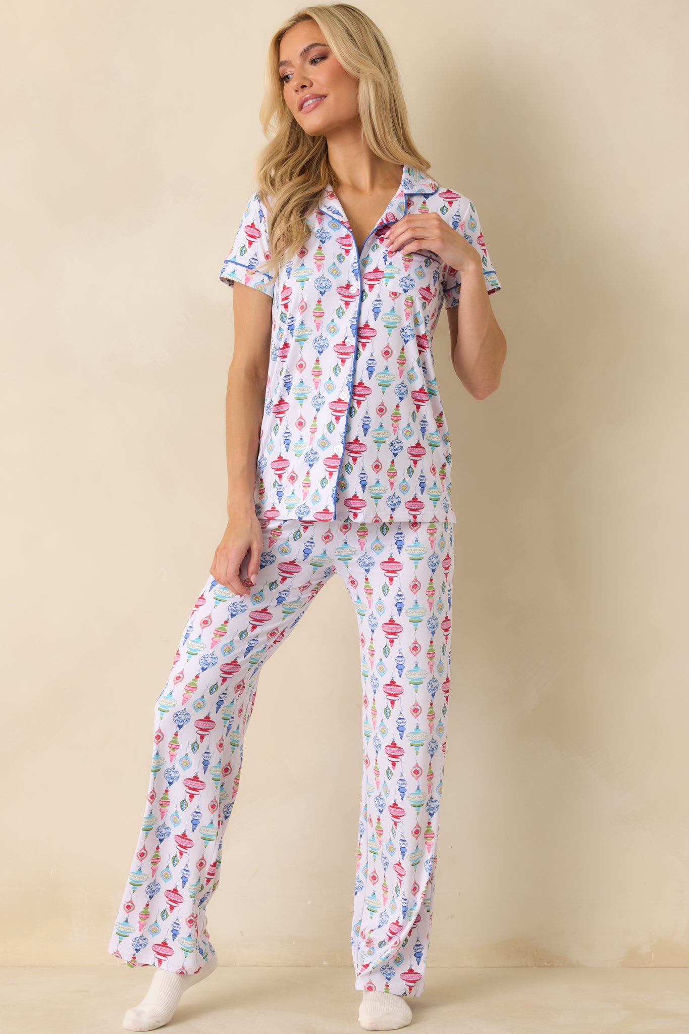 Pajama top with a festive ornament design, tidy piping accents, and a chest pocket.