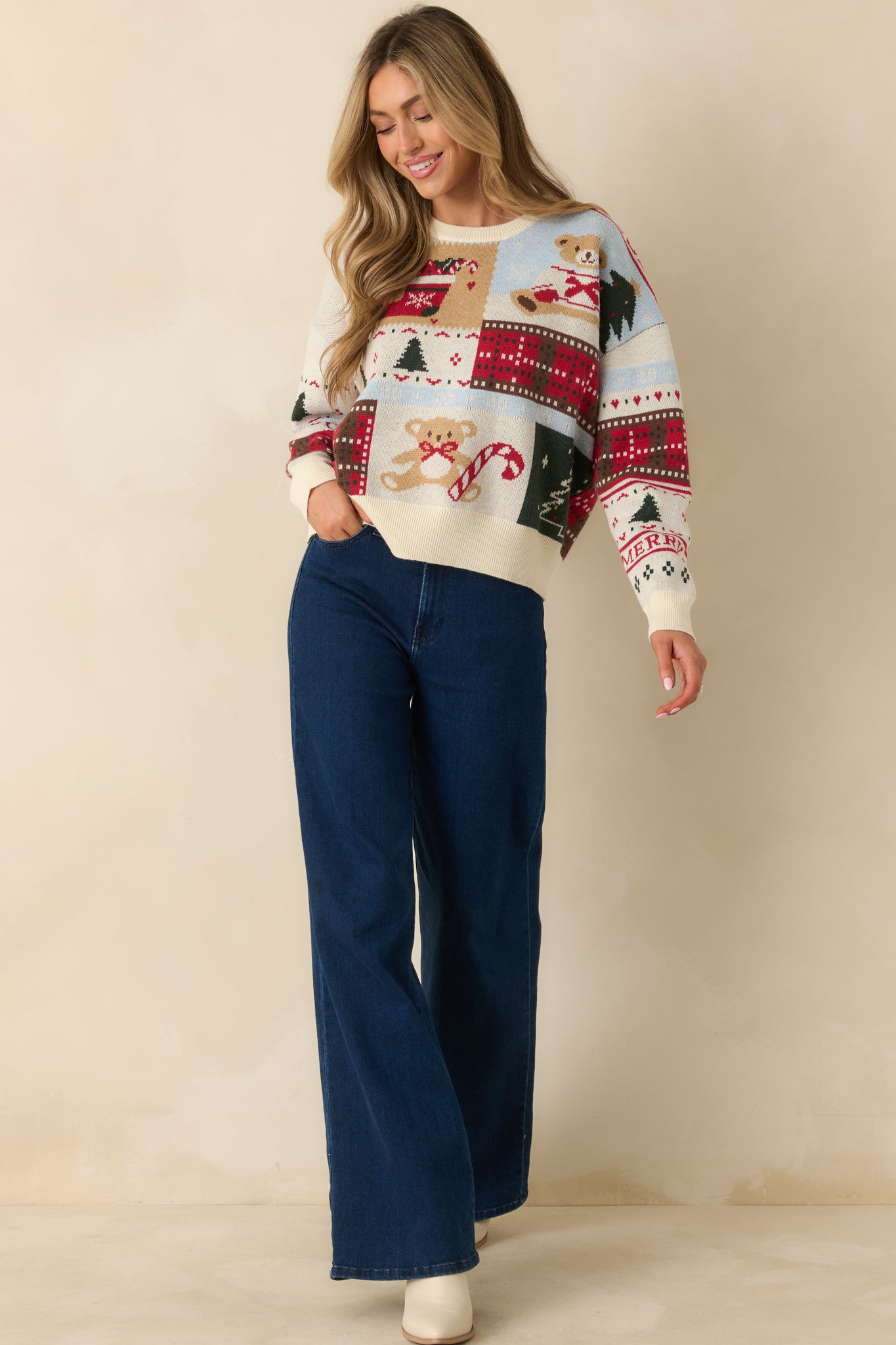 Playful patchwork sweater showcasing colorful Christmas motifs in an easygoing, cozy silhouette.