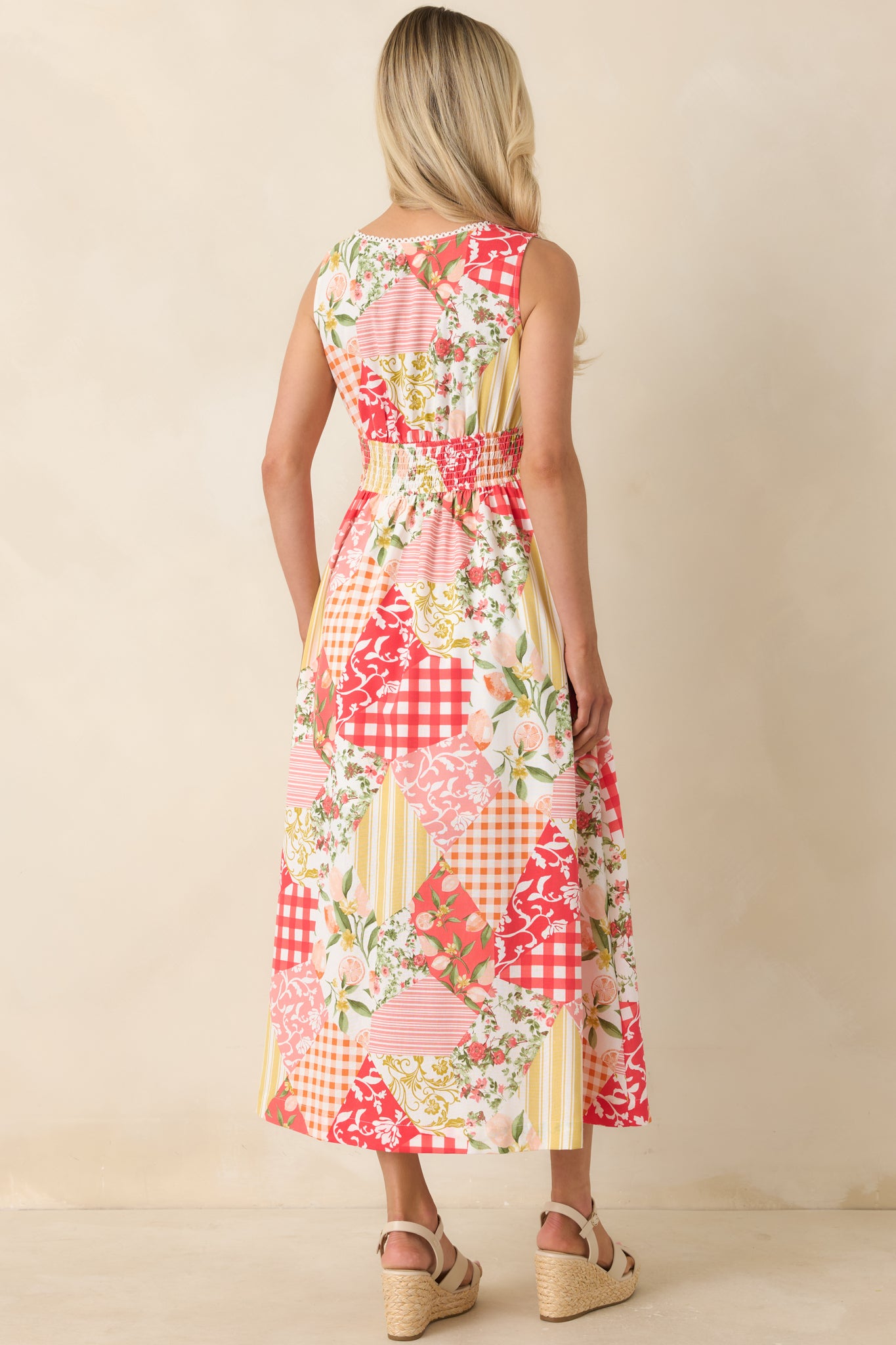 Back view of the multi patchwork midi dress featuring a smocked waistband and flowing lined skirt.