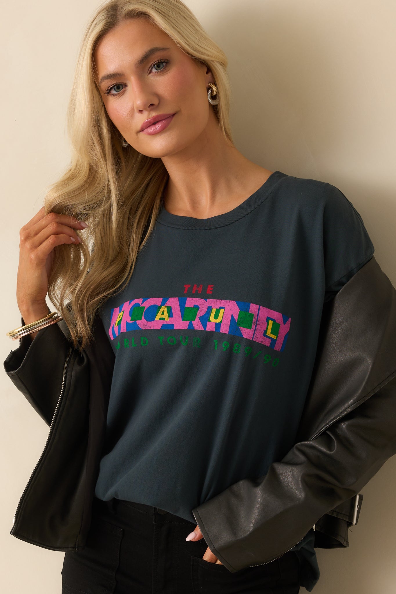 A cropped angled view highlighting the neckline and upper portion of the World Tour inspired graphic.