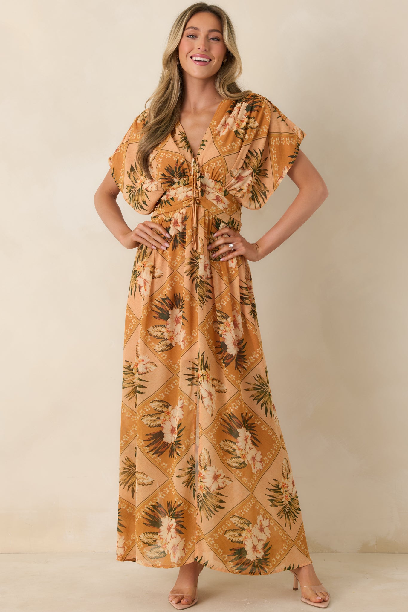 Peach multi print maxi dress with soft patchwork-inspired florals and breezy silhouette, shown from the front.