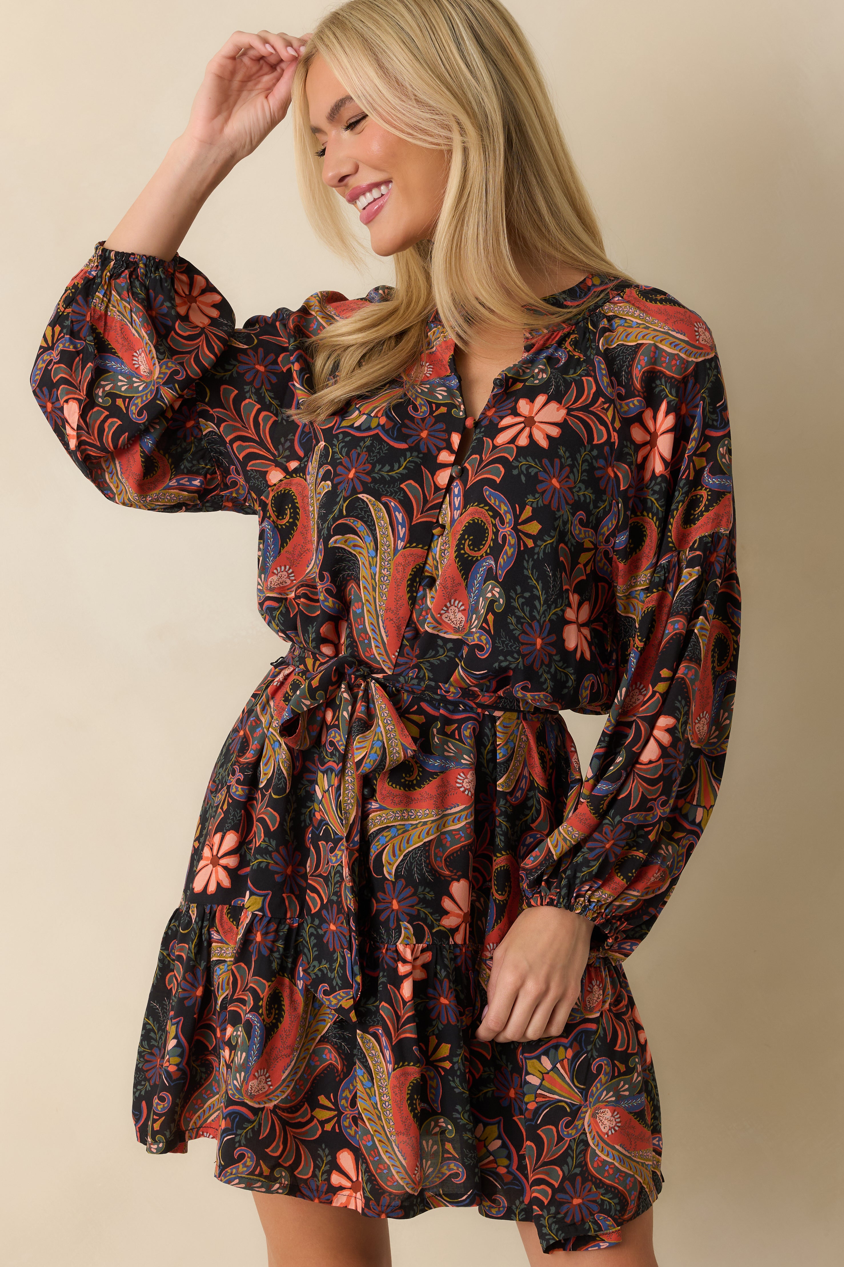 Detail of the peasant sleeve shape and vibrant orange floral paisley pattern.