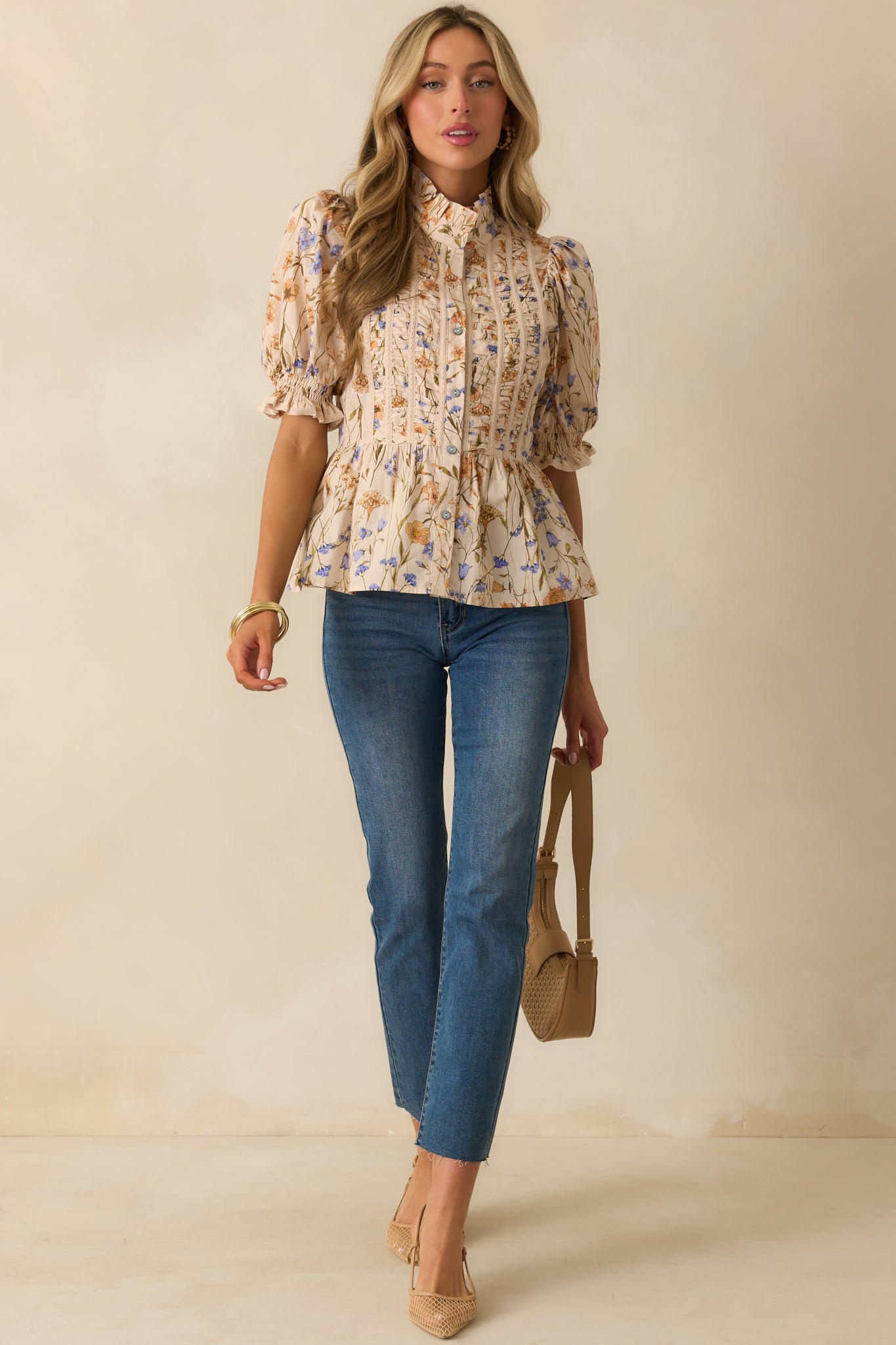 Peplum silhouette top highlighting vertical pintuck detailing and lace trim along the bodice.