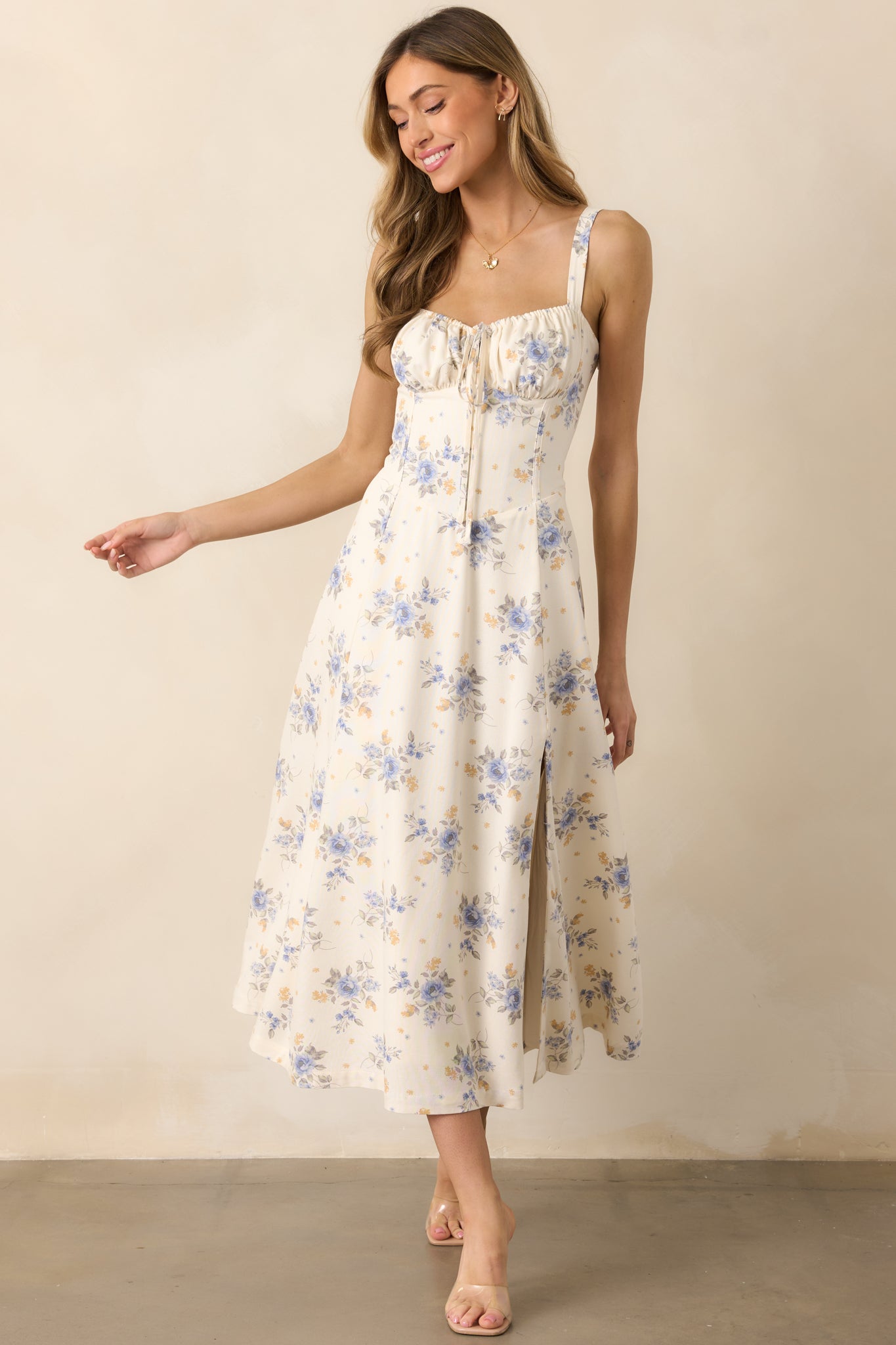 This periwinkle dress stuns with a structured bodice, a lace-up corset detail peeking through, and a flowy silhouette.