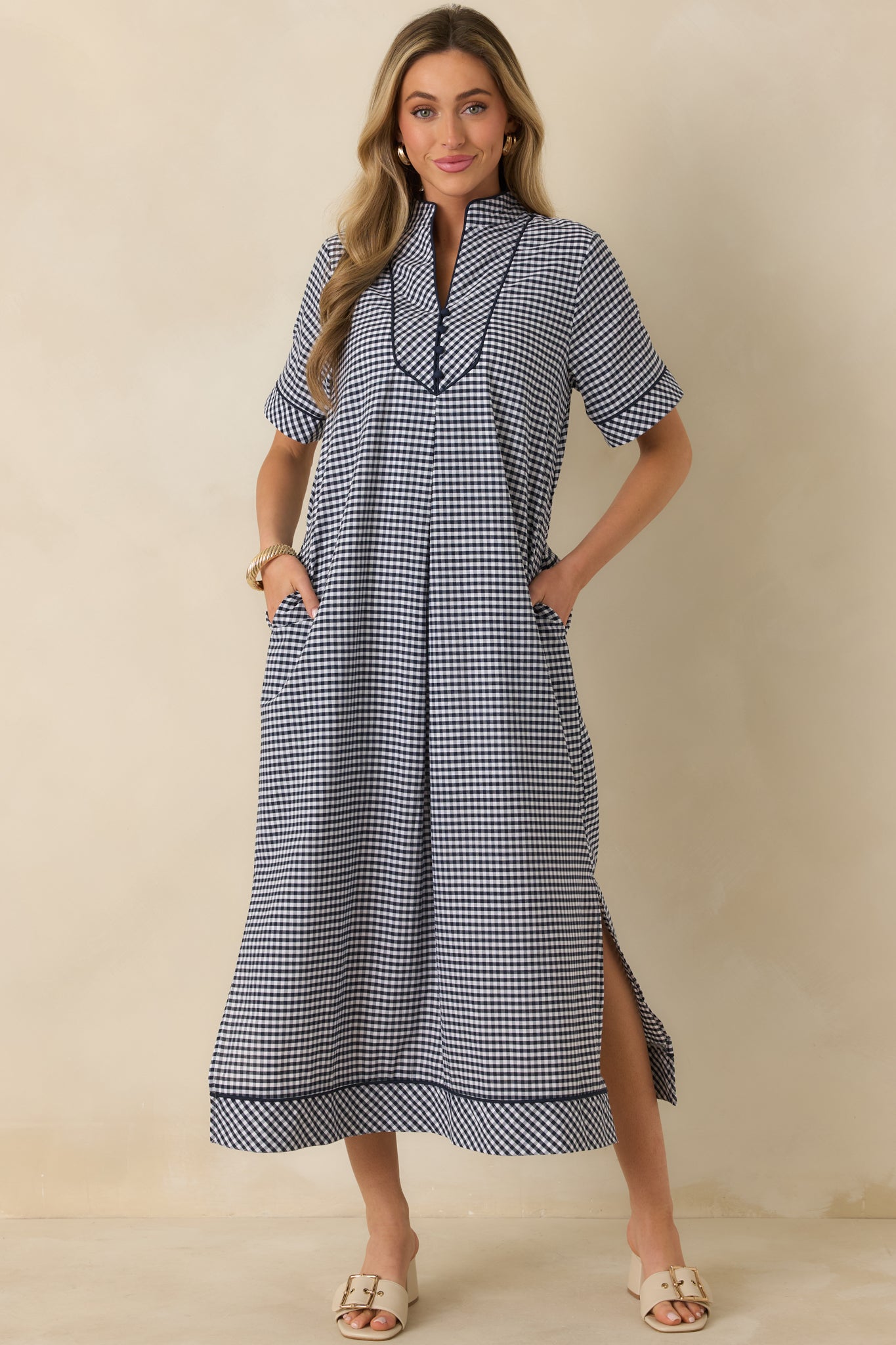 Front-facing perspective emphasizing the relaxed fit through the body and subtly flared skirt of the navy gingham dress.