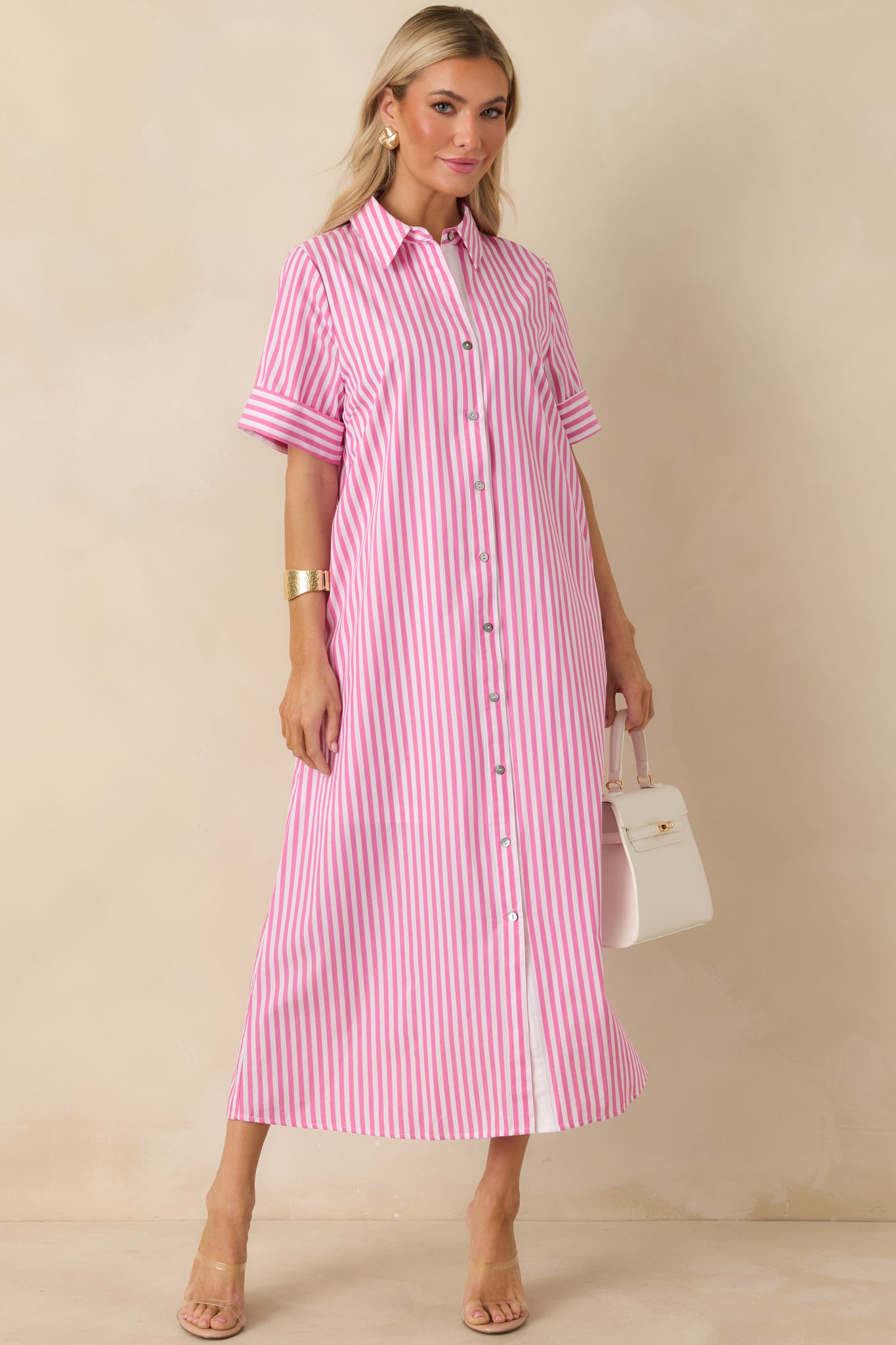 Pink and white striped shirt dress with collared neckline, button-front closure, and short cuffed sleeves.