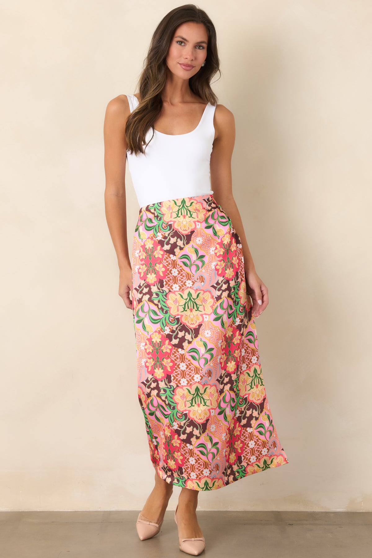 Midi skirt with pink, coral, yellow, green, and chocolate brown floral motifs arranged across the printed fabric.