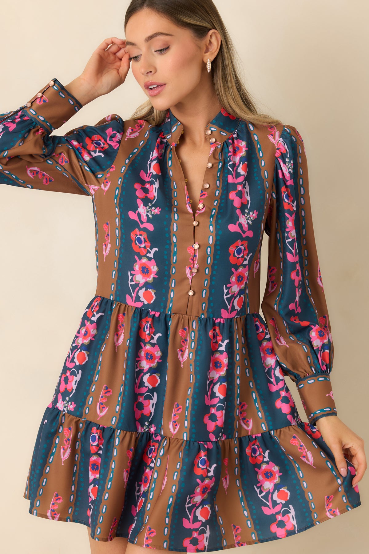 Pink, coral, and ivory blossoms decorate alternating teal and caramel stripes across the dress.