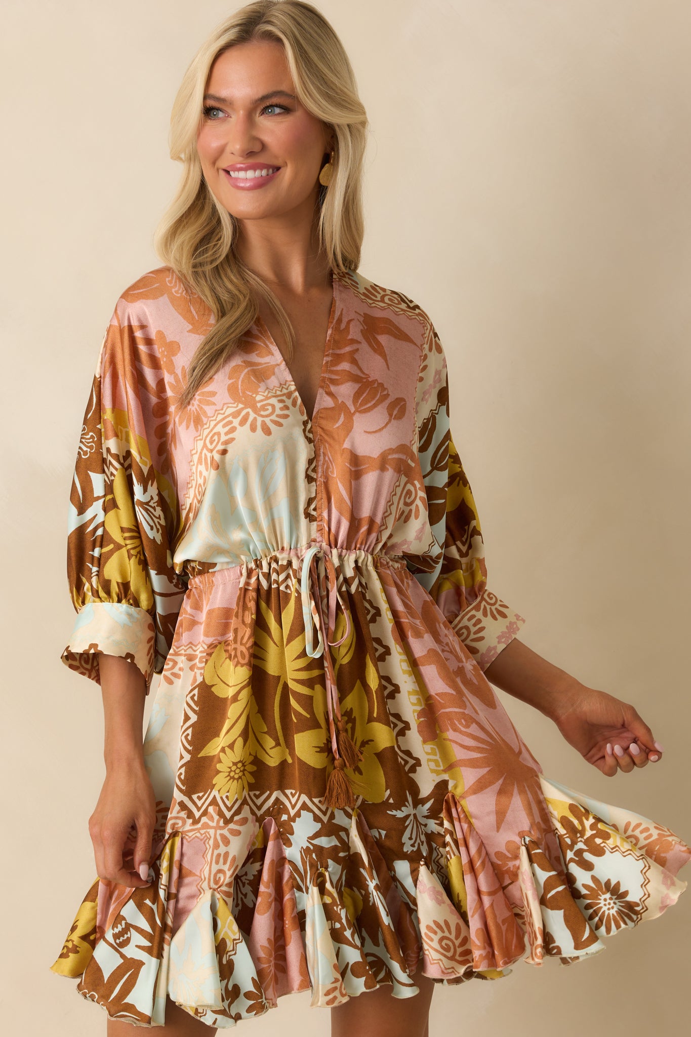 Close-up of the pink coral patchwork dress highlighting the v-neckline and drawstring waist.