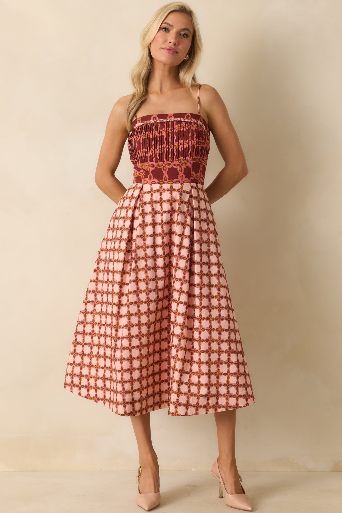 Flowing pink dress with a pleated skirt and smocked back panel.