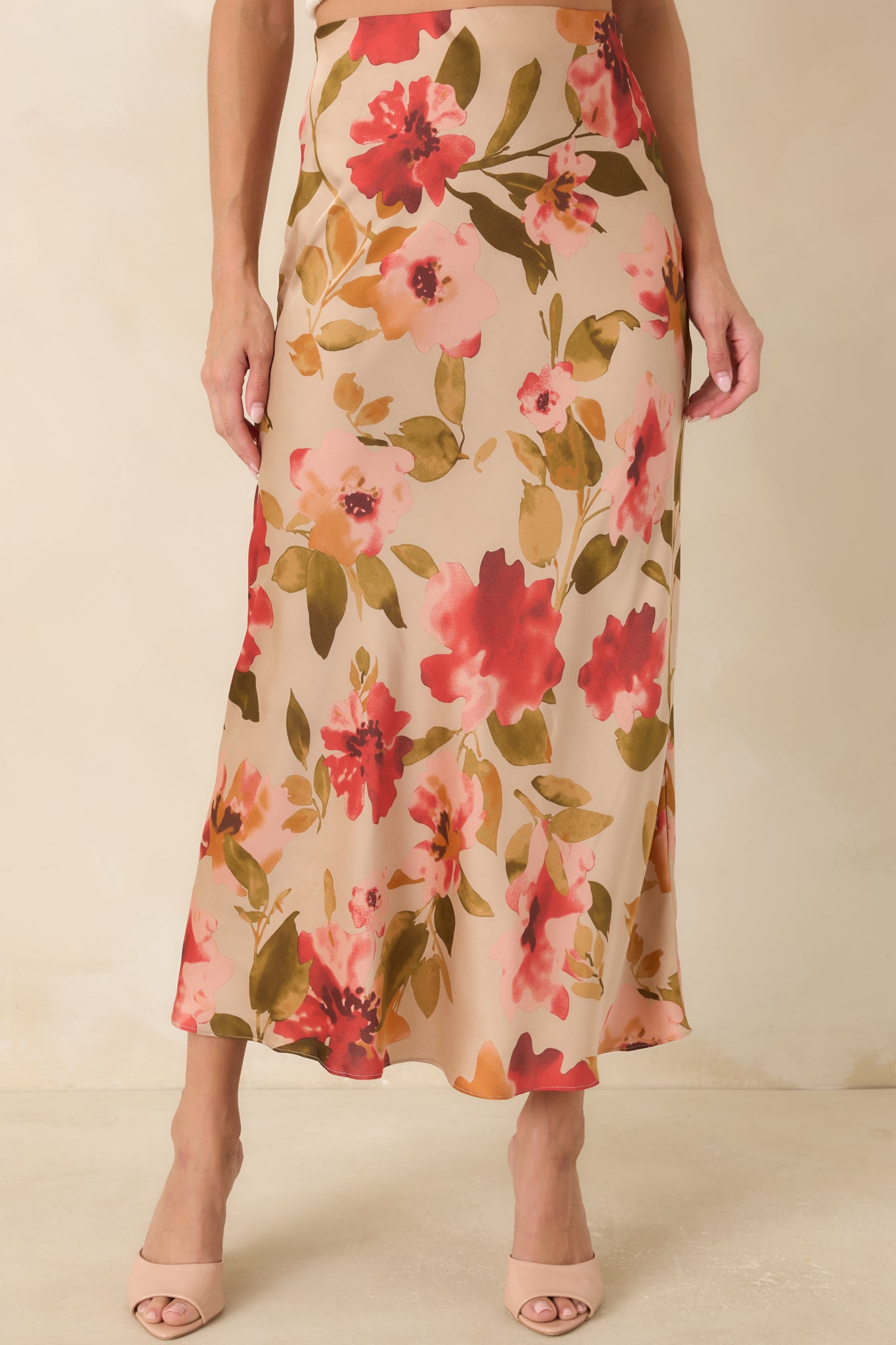 Detailed look at the skirt fabric featuring soft pink floral accents and a flowing maxi length design.