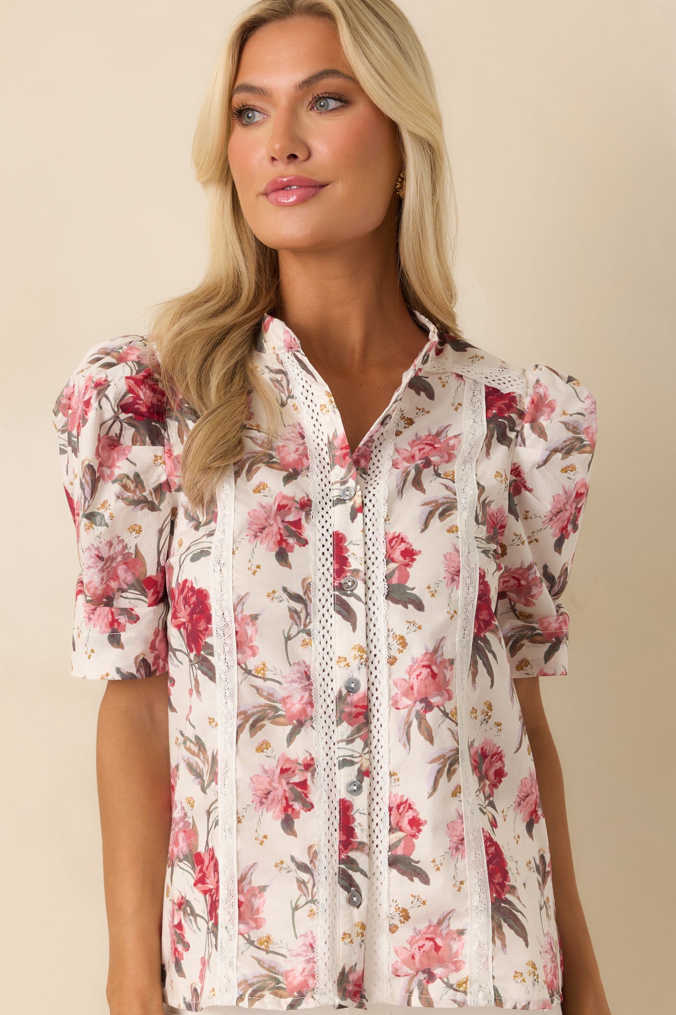 Cropped view focusing on the neckline and upper chest, showing the button closure and lace trim.