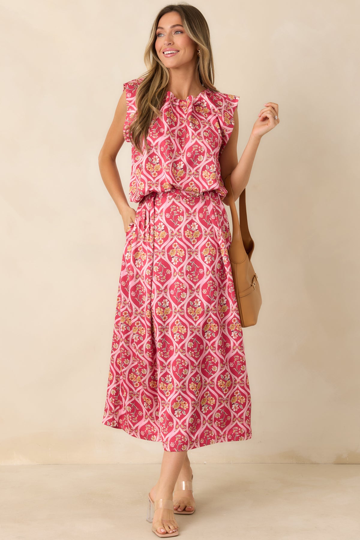 Pink floral top with pale pink trellis motifs, ruffled shoulders, and a rounded bubble hem.
