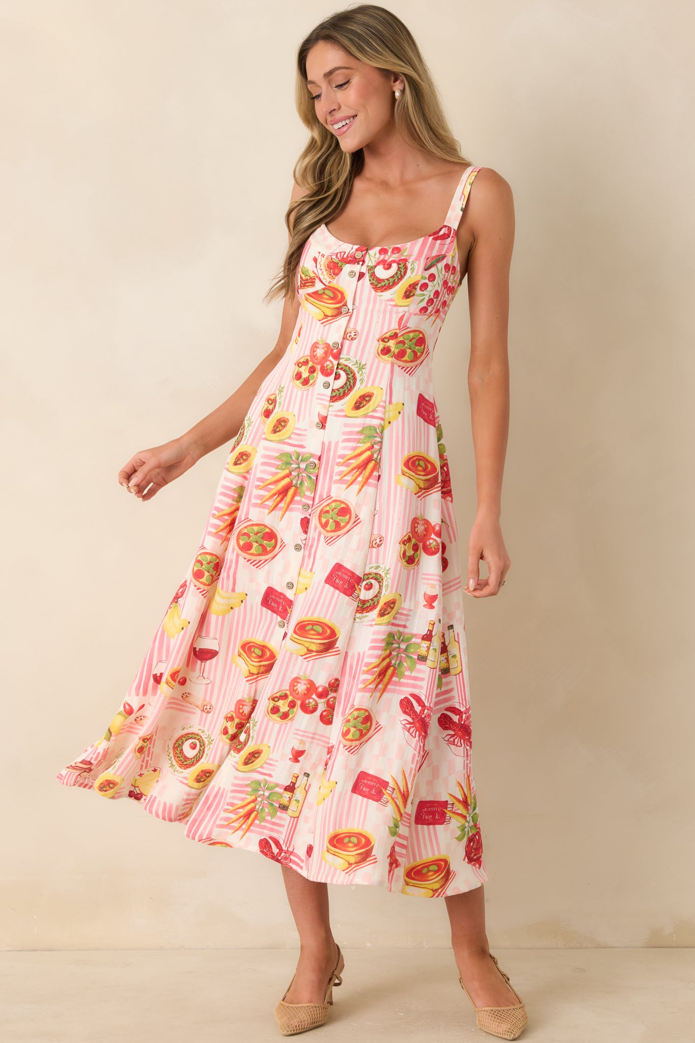Relaxed fit pink striped midi dress with a whimsical multi-food print, adjustable straps, and a lightweight flowy midi-length design.