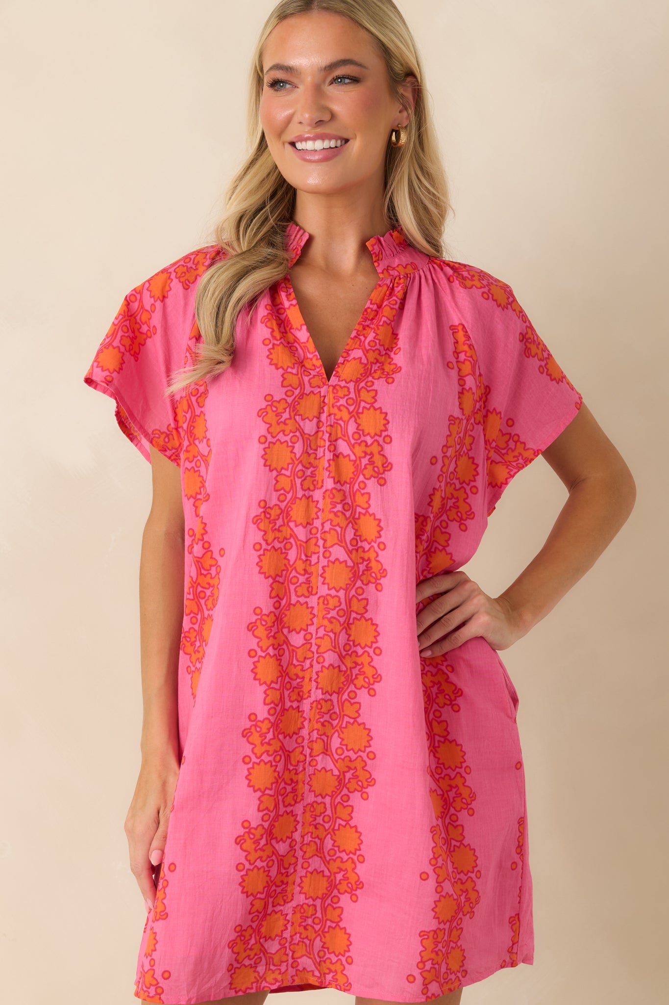 Detailed look at the vibrant pink and orange floral print fabric.