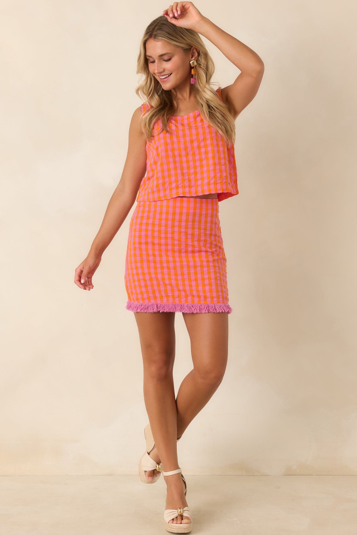 Pink and orange plaid cropped cotton tank featuring a flattering square neckline, wide shoulder straps, and a lightweight woven finish.