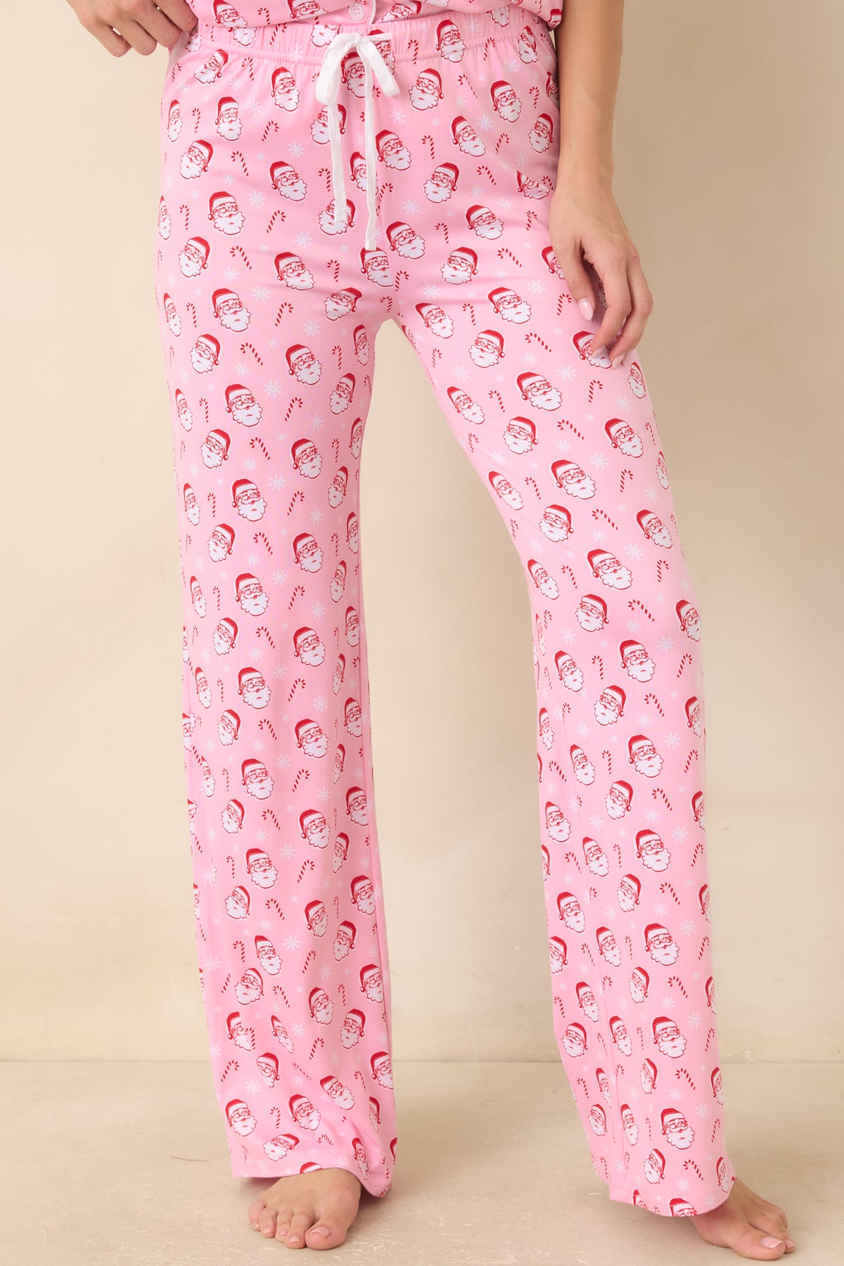 Light pink pajama pants feature an elastic waistband with an adjustable drawstring for a flexible fit.