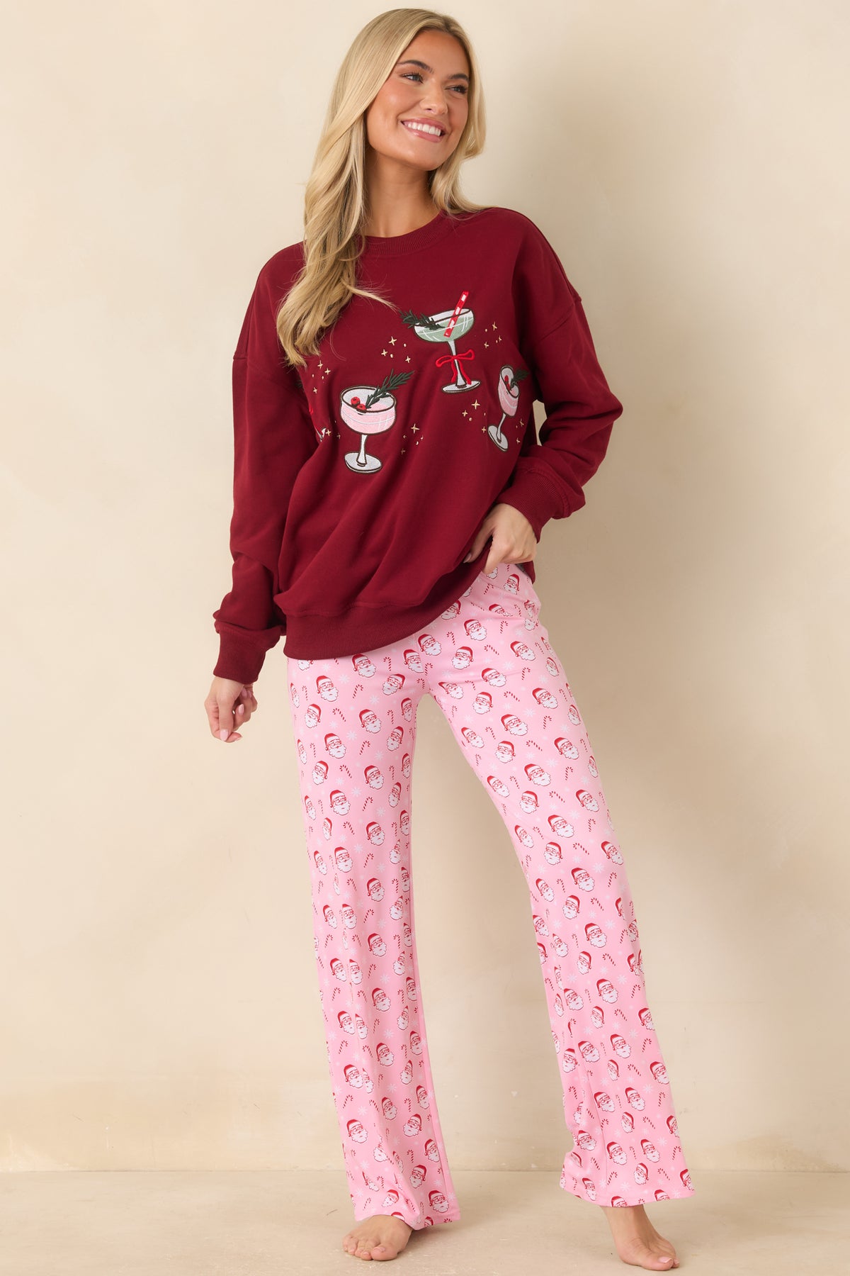 Relaxed pullover top featuring embroidered pink and sage cocktail glasses with greenery, berry accents, and a red bow.