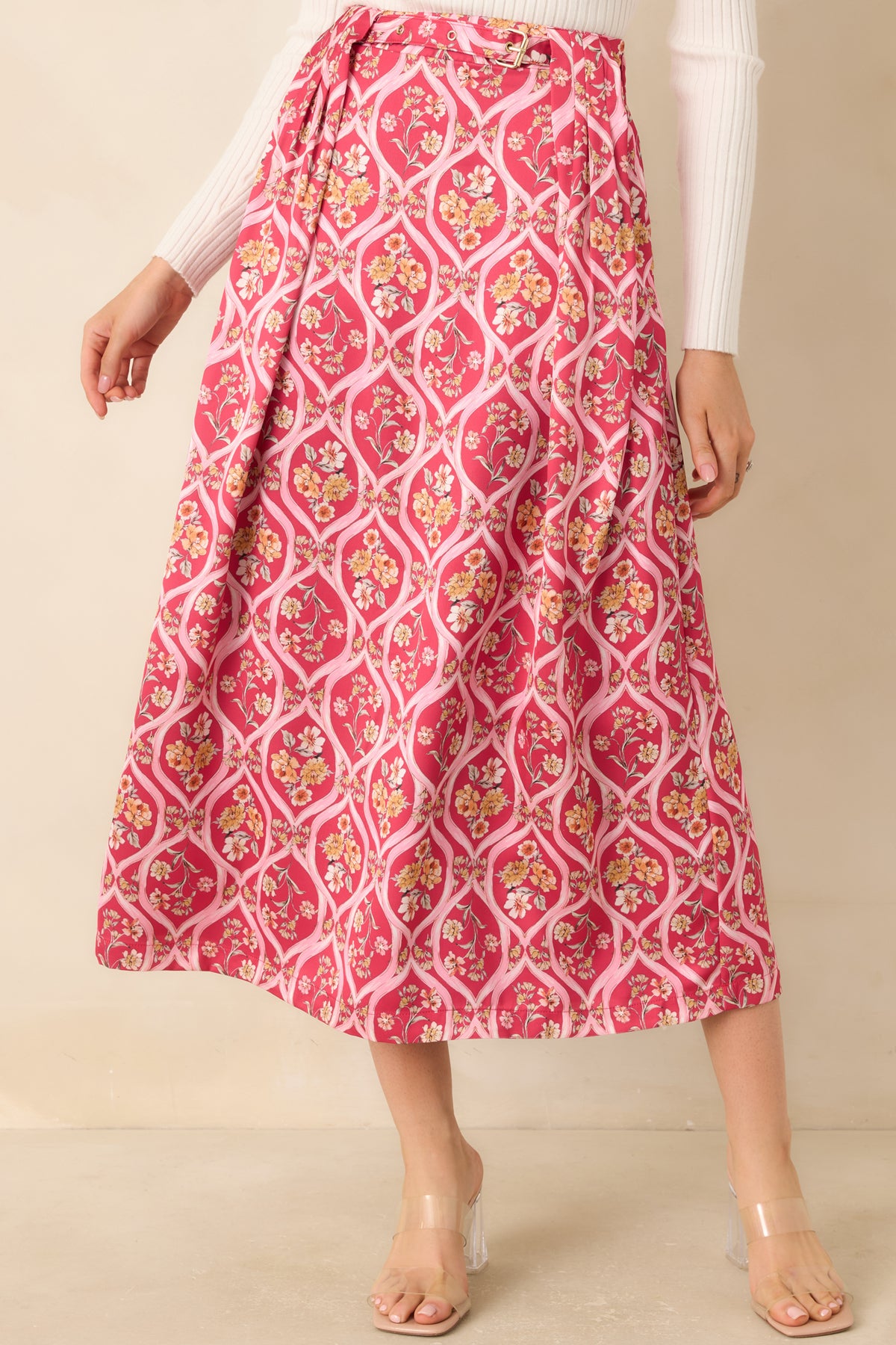 Rich pink skirt showcasing peach, yellow, and ivory floral bouquets against a pale pink trellis pattern.