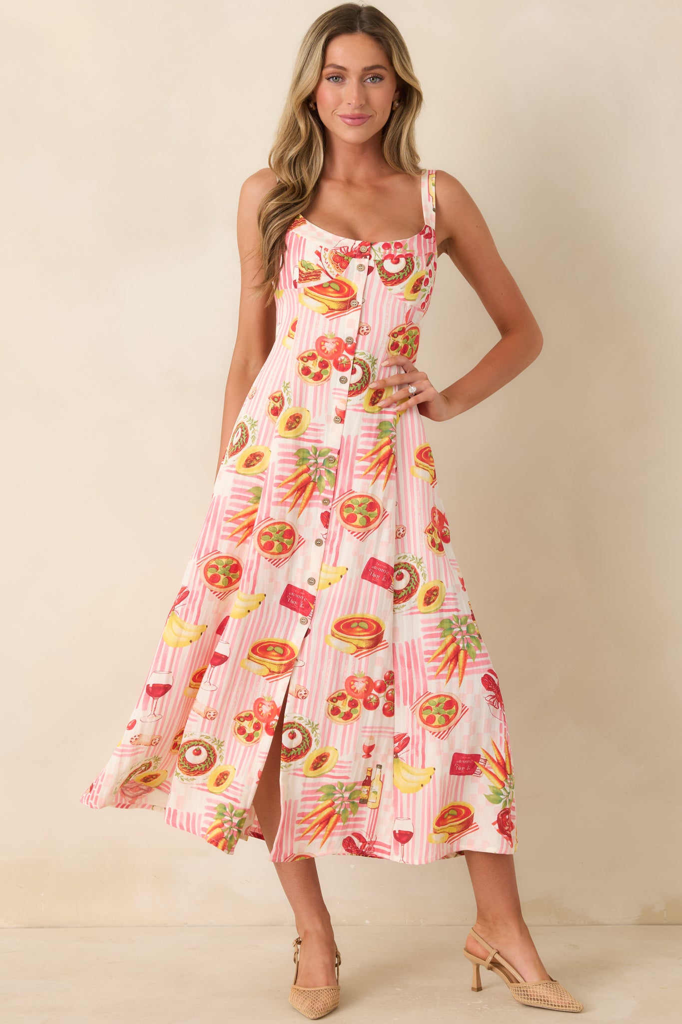 Pink striped midi dress featuring a playful multi-food novelty print, scoop neckline, adjustable shoulder straps, button front, and relaxed flowy silhouette.