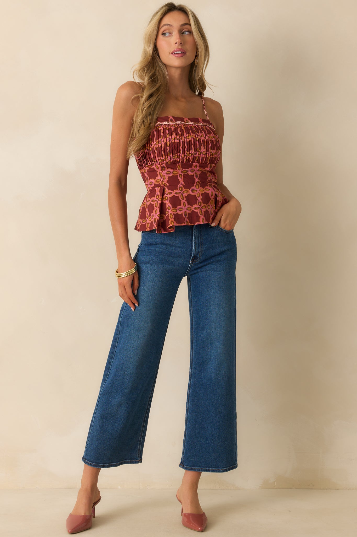 Fitted waist pink top with smocked back panel and colorful geometric pattern.