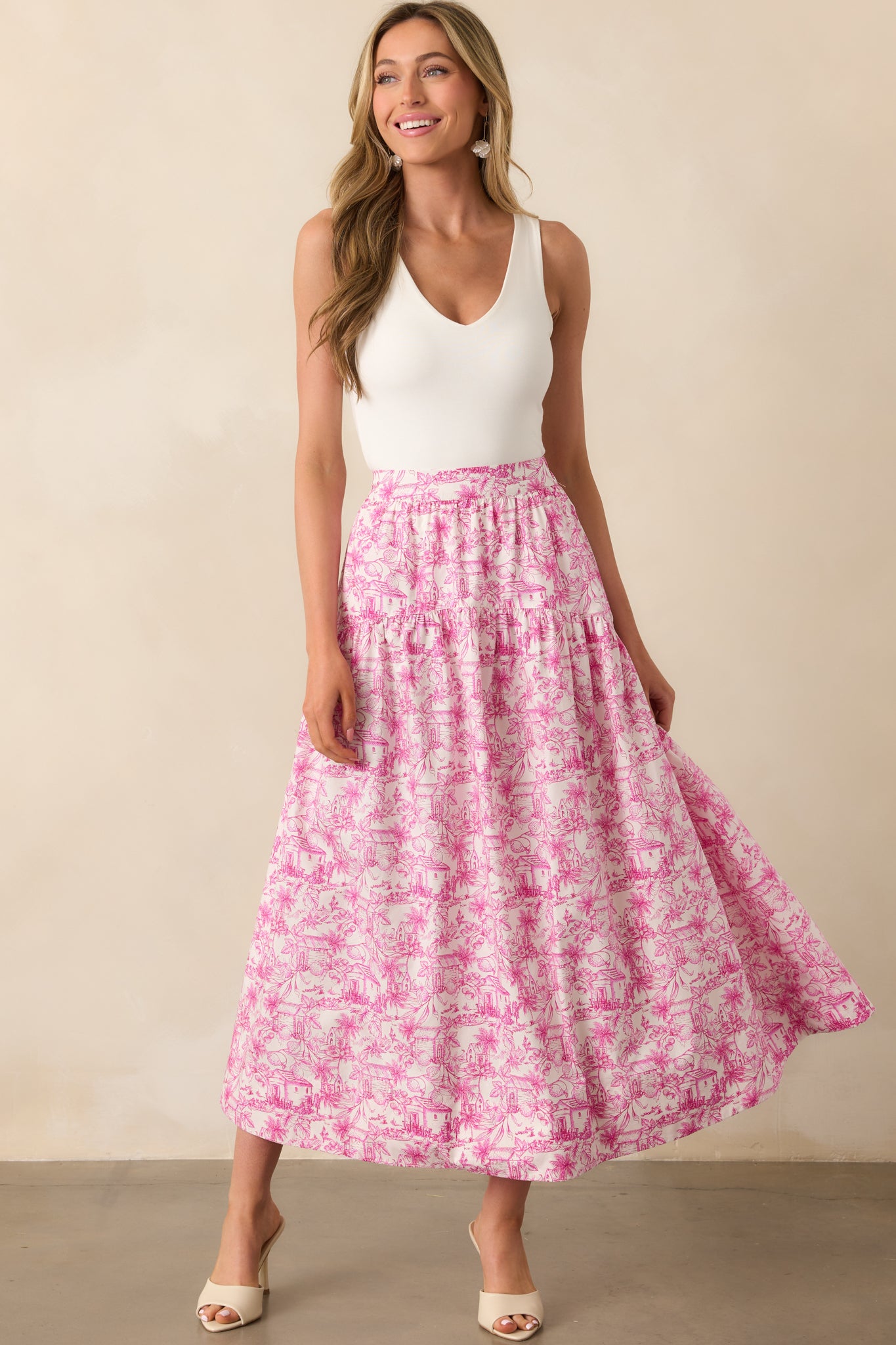 Pink tropical toile print maxi skirt with a drop waist silhouette shown in a full body front view.
