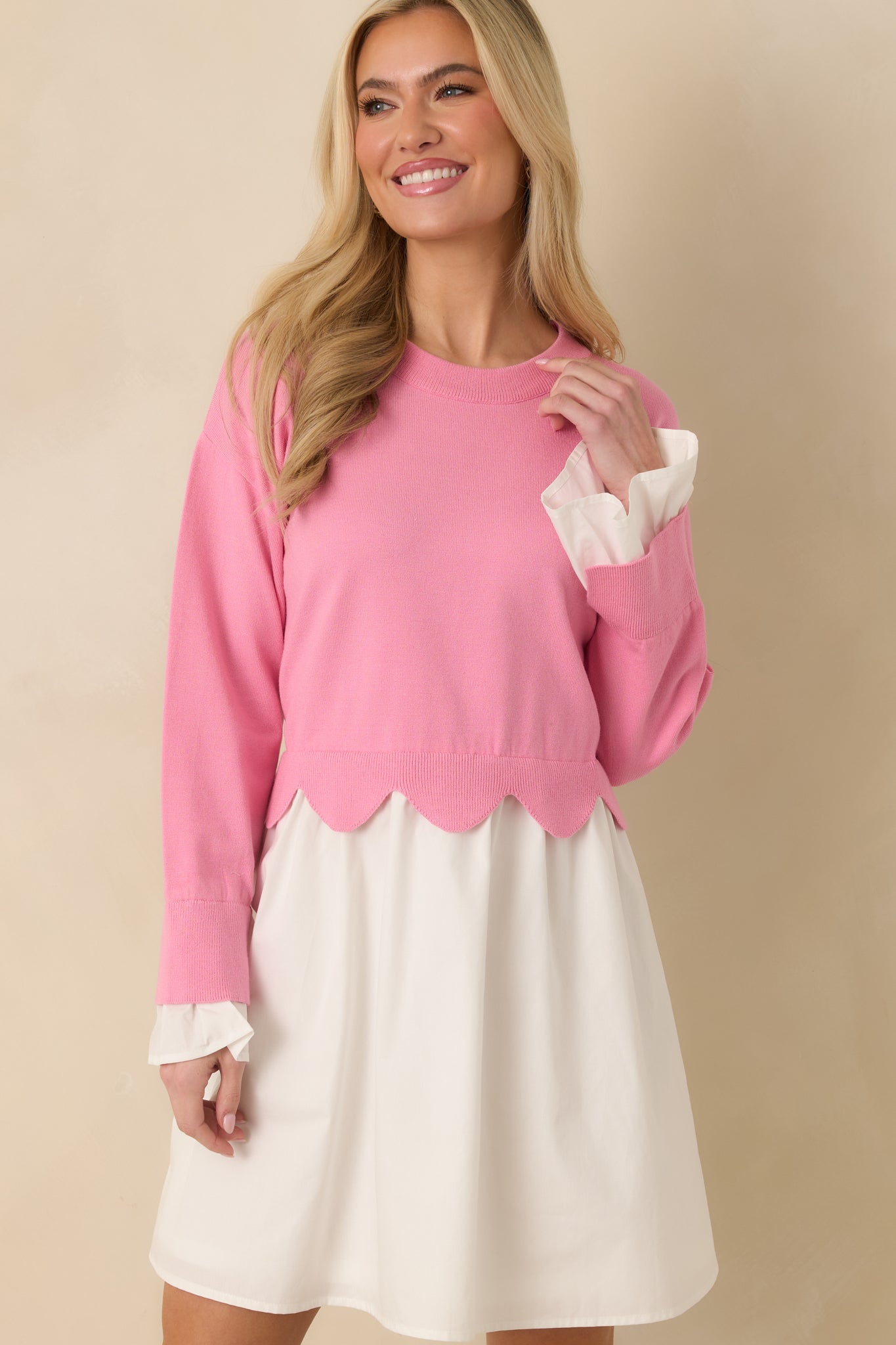 Cropped detail of the woven skirt portion of the mini dress, showing the lightweight, flowy fabric beneath the scalloped waist hem.