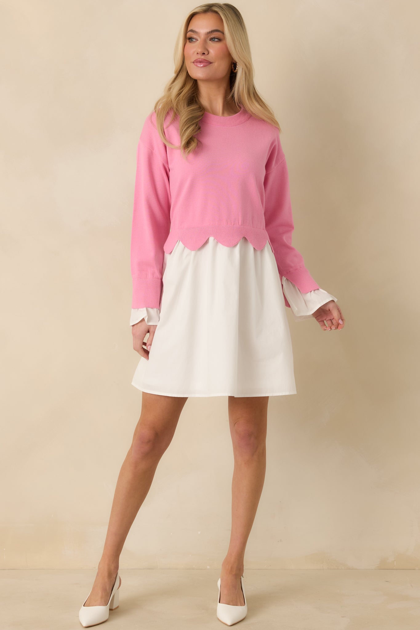 Relaxed-fit mini dress with a pink and white knit top, scalloped hem detailing at the waist, long sleeves, and a lightweight woven skirt for gentle movement.